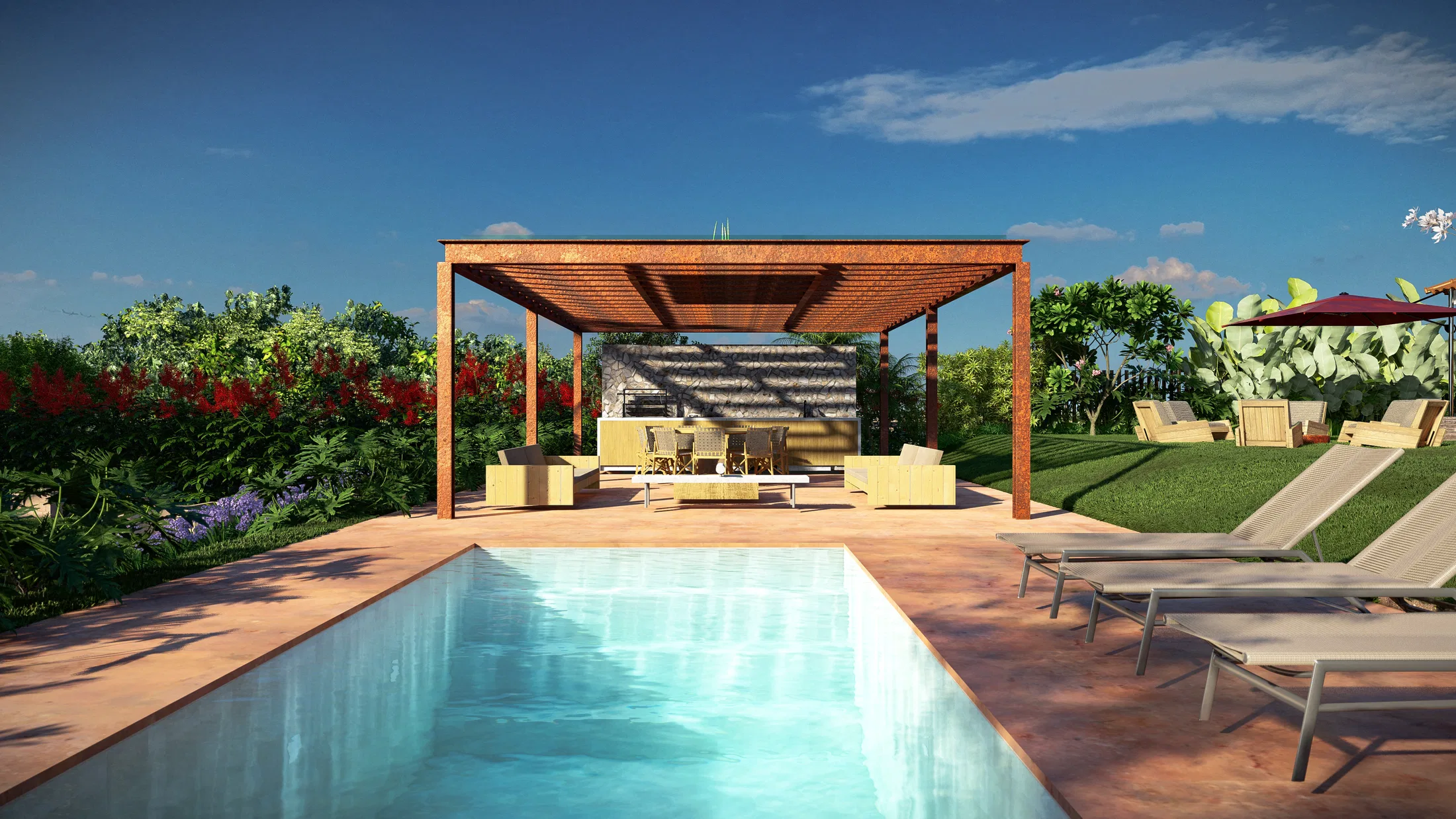 Swimming pool with a timber pergola sheltering sofas and a table, terracotta deck, sunloungers and red flowering shrubs under a clear sky.