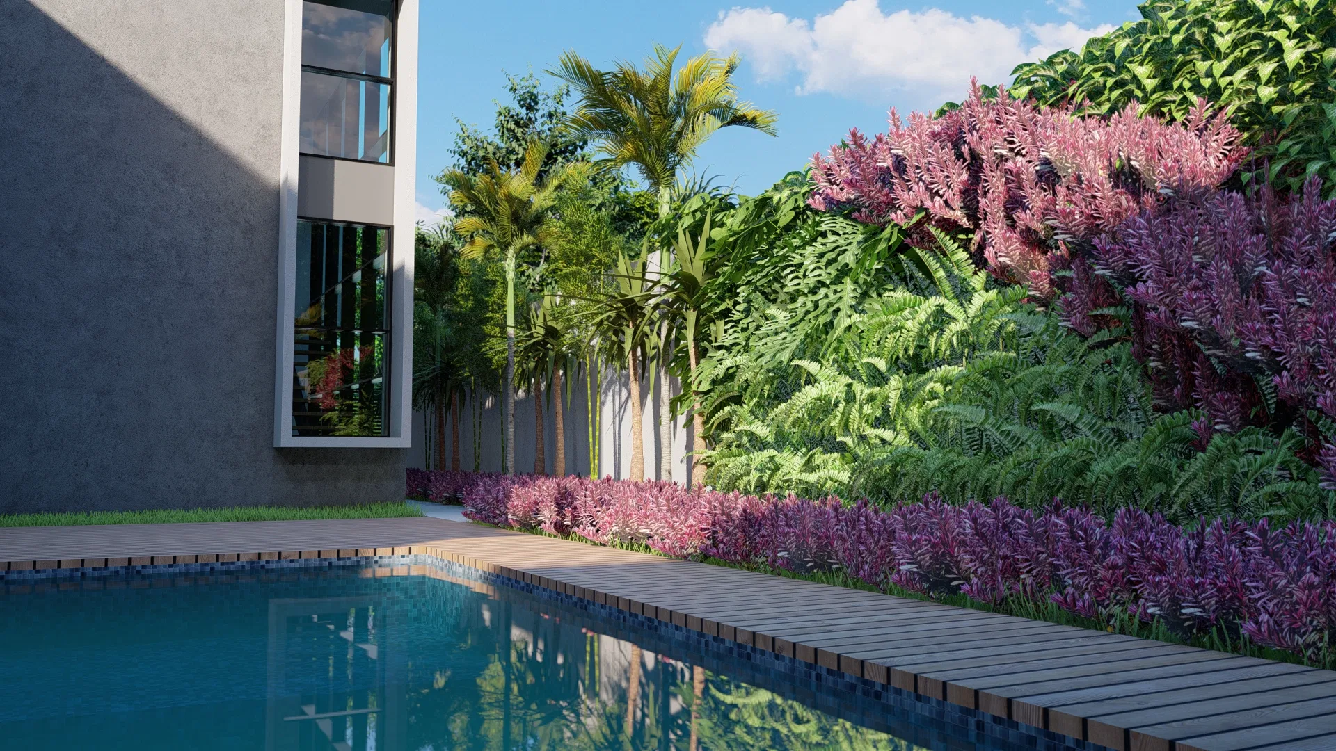Pool with a wooden walkway beside the house, borders of magenta flowers and ferns and palms lined along the boundary under a blue sky