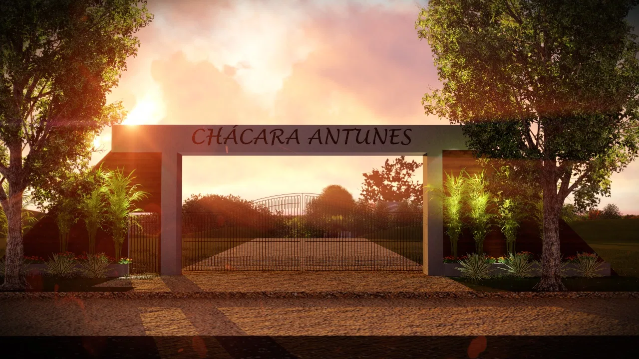 Entry portal framed by trees at sunset, with the estate's name sign and an iron gate visible behind it