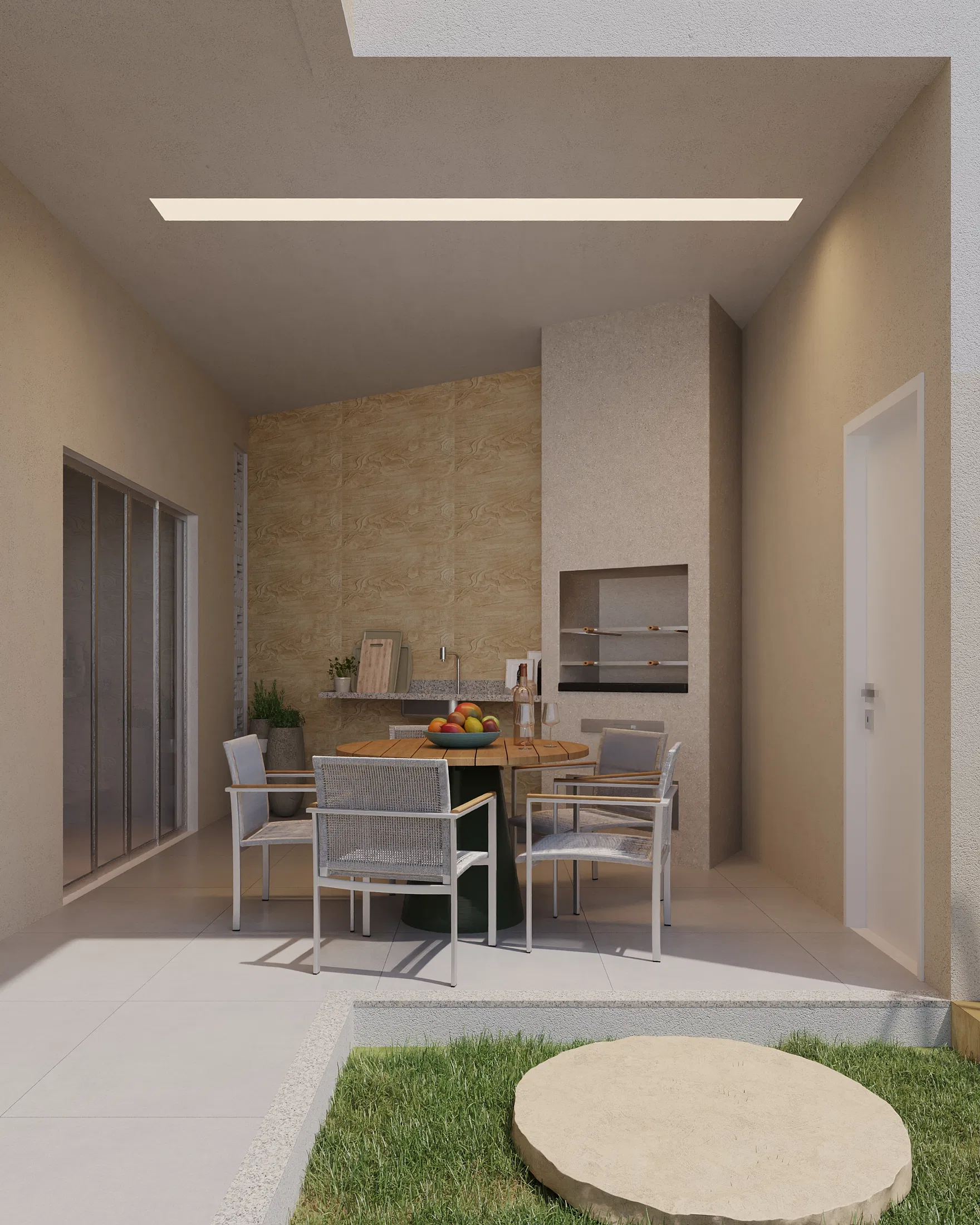 Another angle of the covered outdoor kitchen, with a round table, a built-in grill niche and a sliding glass door to the side