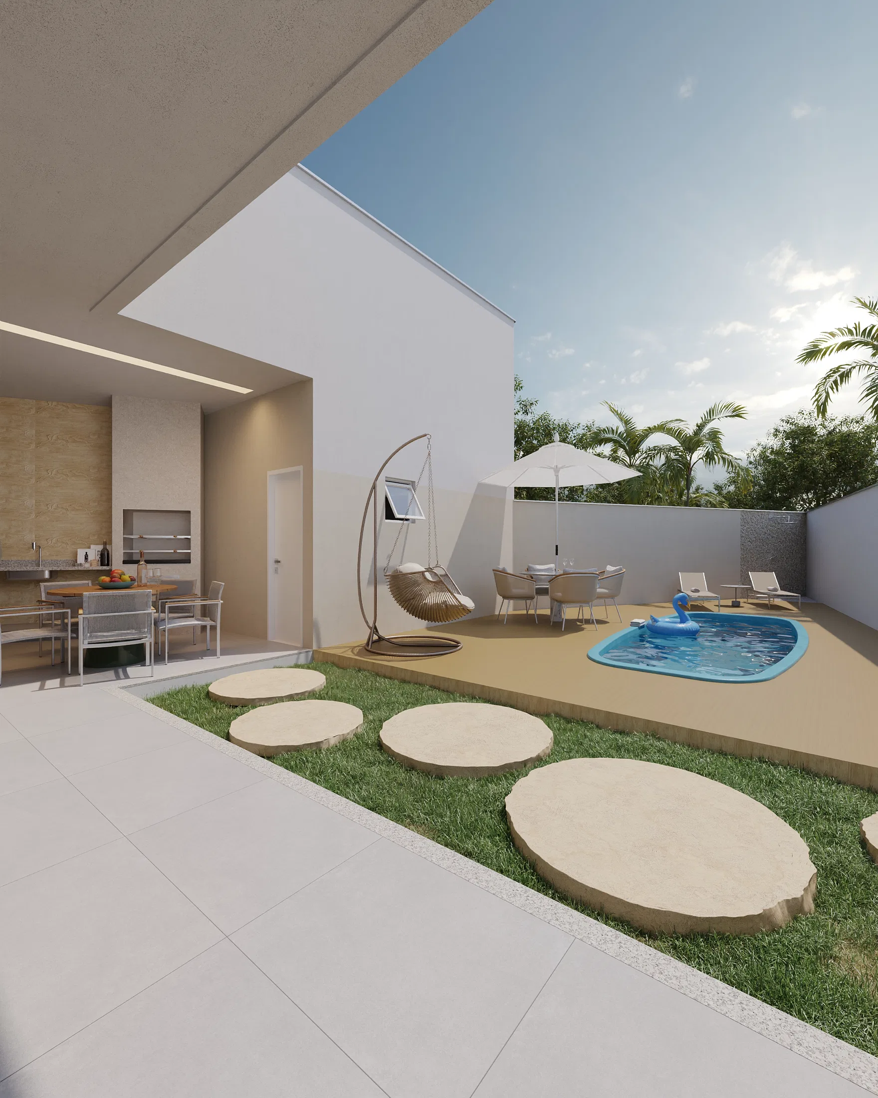Another view of the backyard with the pool, a table with an umbrella, white loungers and a lawn framed by natural stone pavers