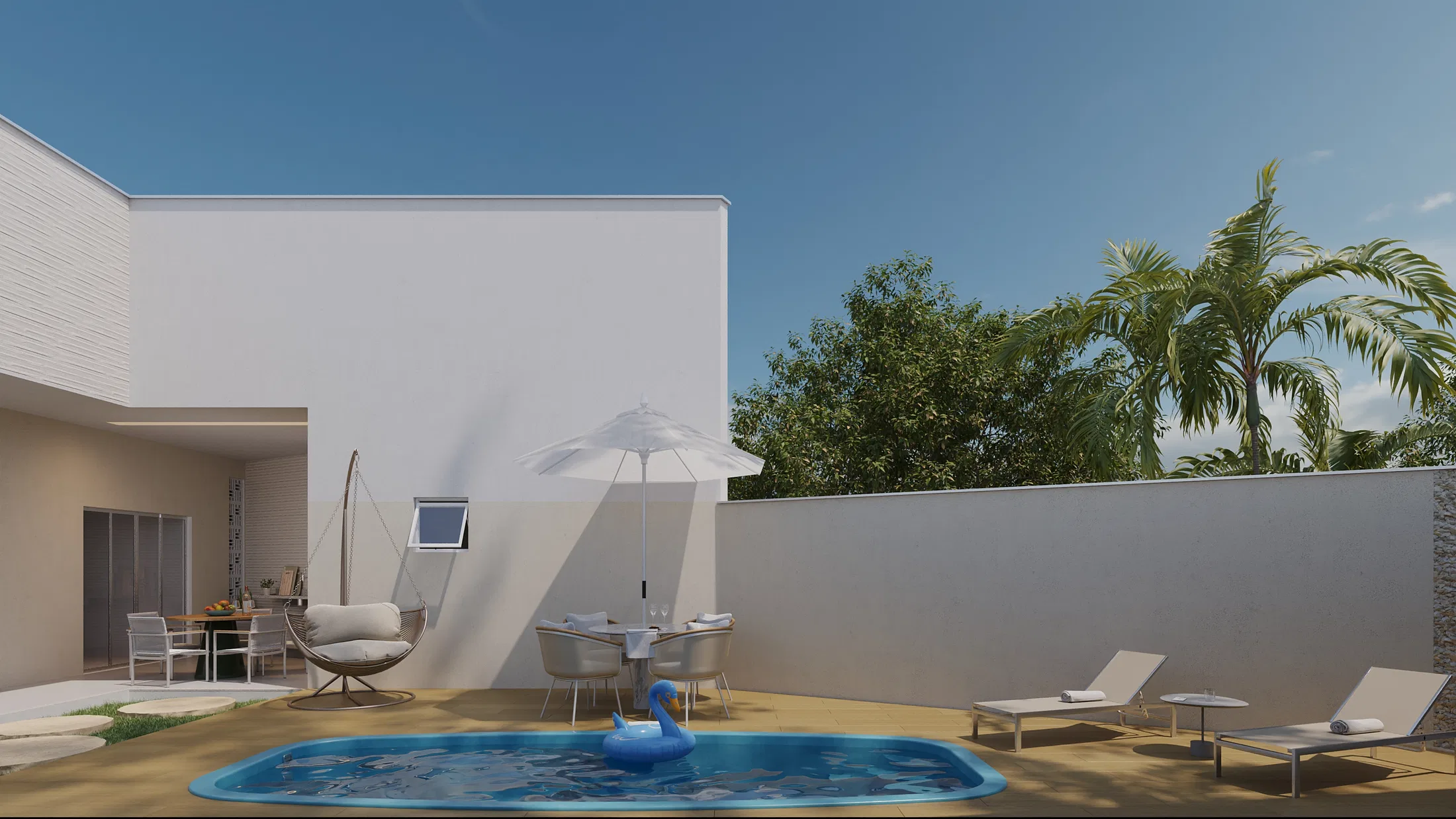 Outdoor view of the pool with an open umbrella, loungers and palm trees in the background under a blue sky