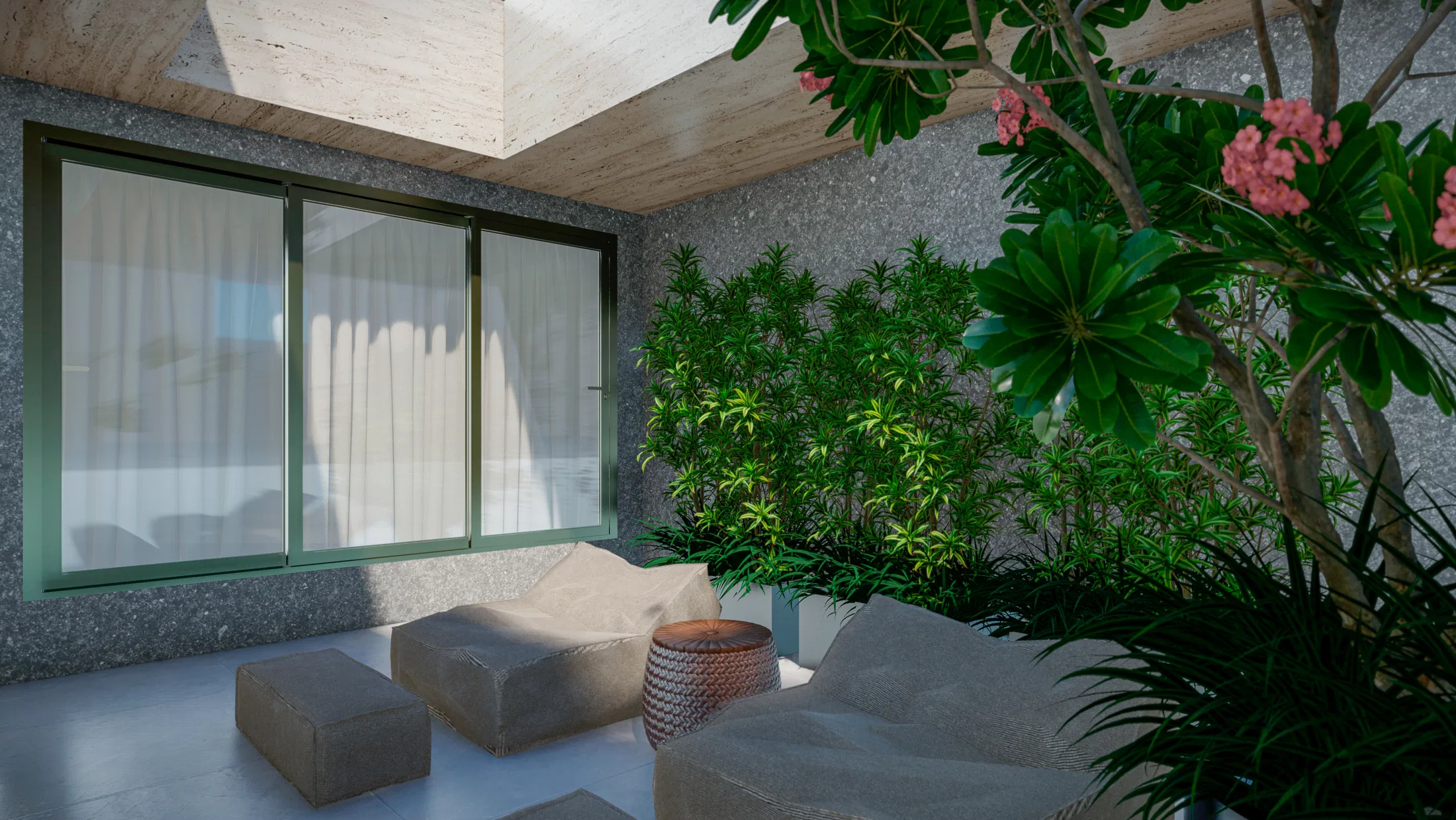 Inner courtyard with textured walls, beige armchairs and poufs, a woven basket and flowering shrubs beneath a skylight.