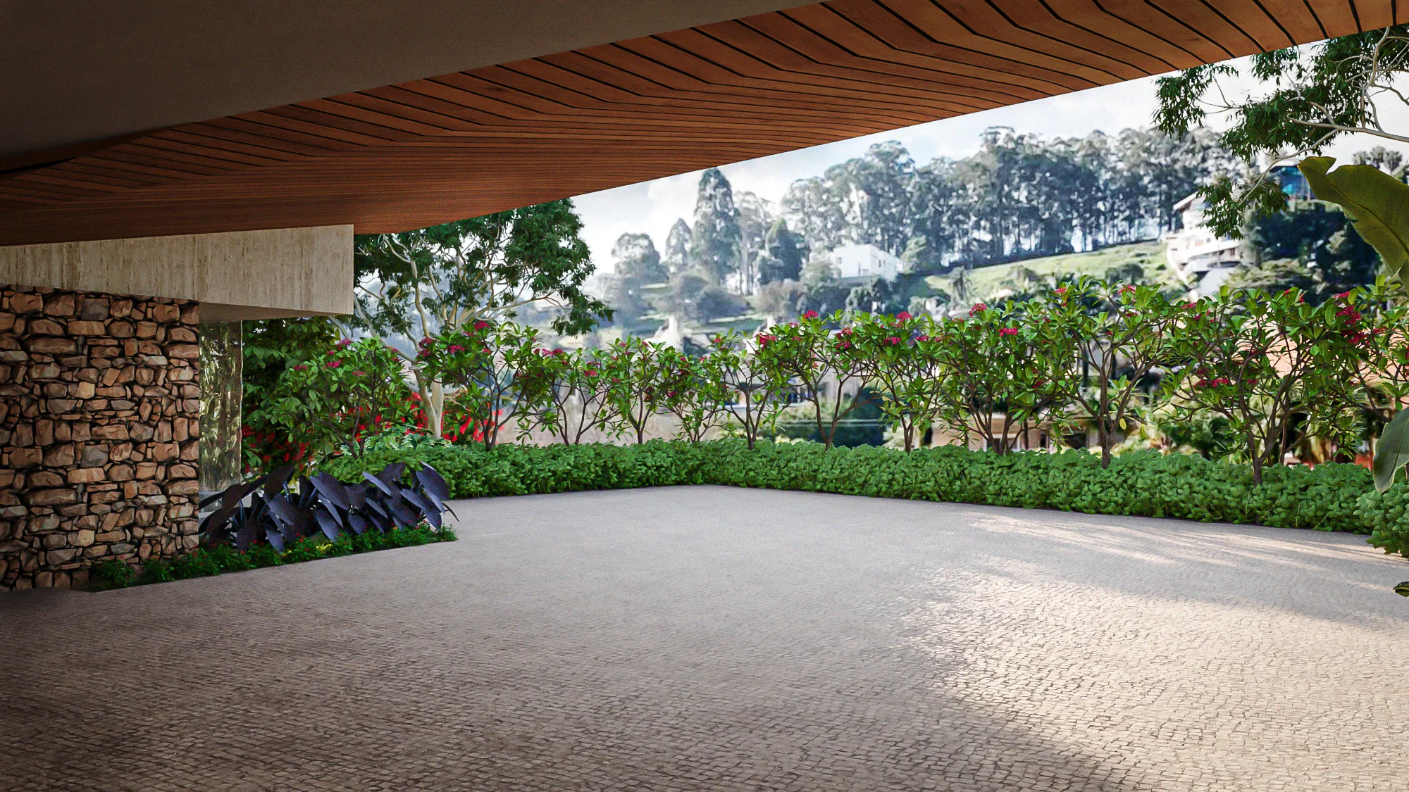 Covered driveway with a curved wood ceiling, a stone wall and flowering shrubs lining the cobblestone paving