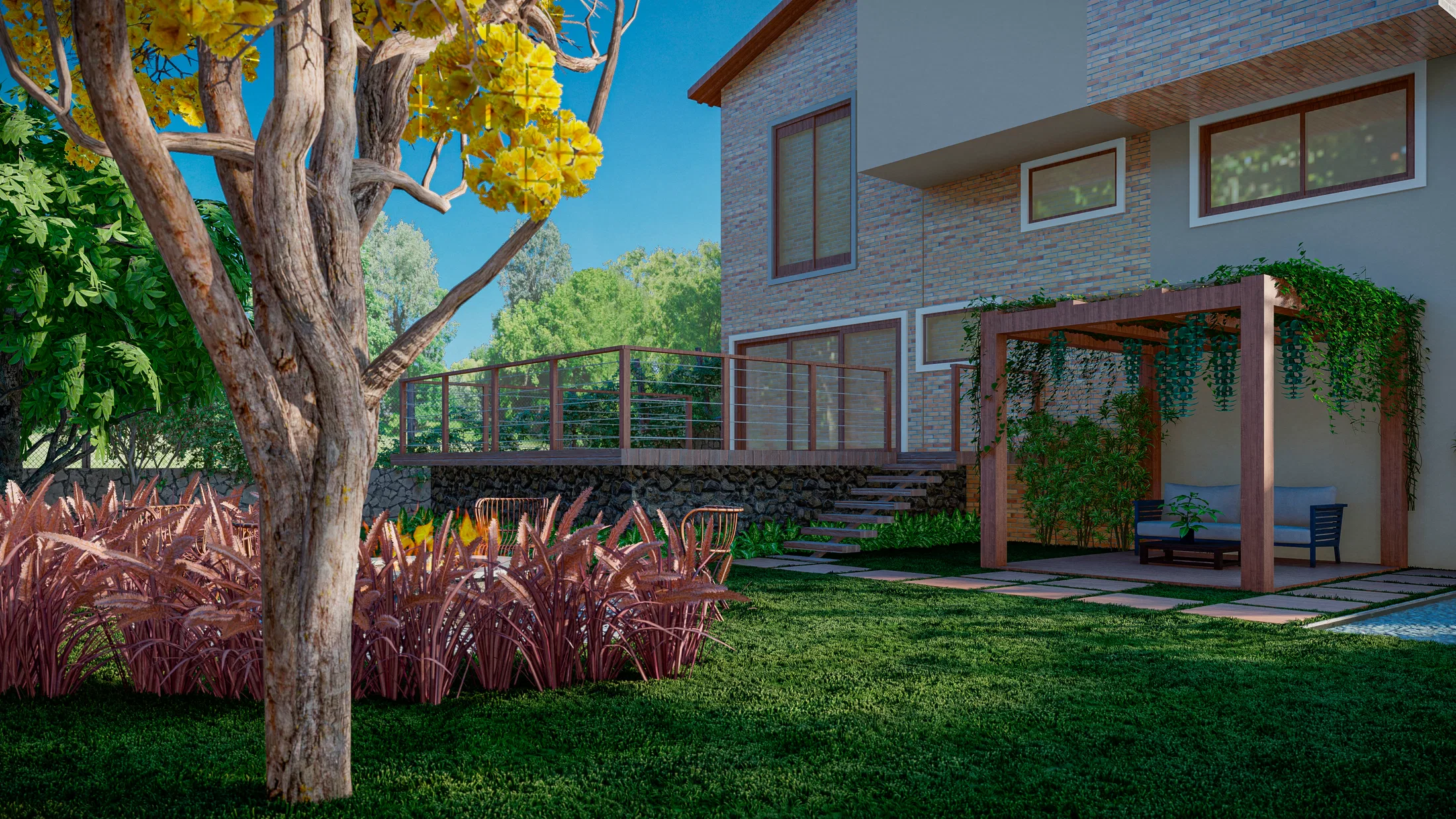Raised deck with stairs and a glass railing beside the brick house, a wooden pergola and a yellow-flowering tree alongside