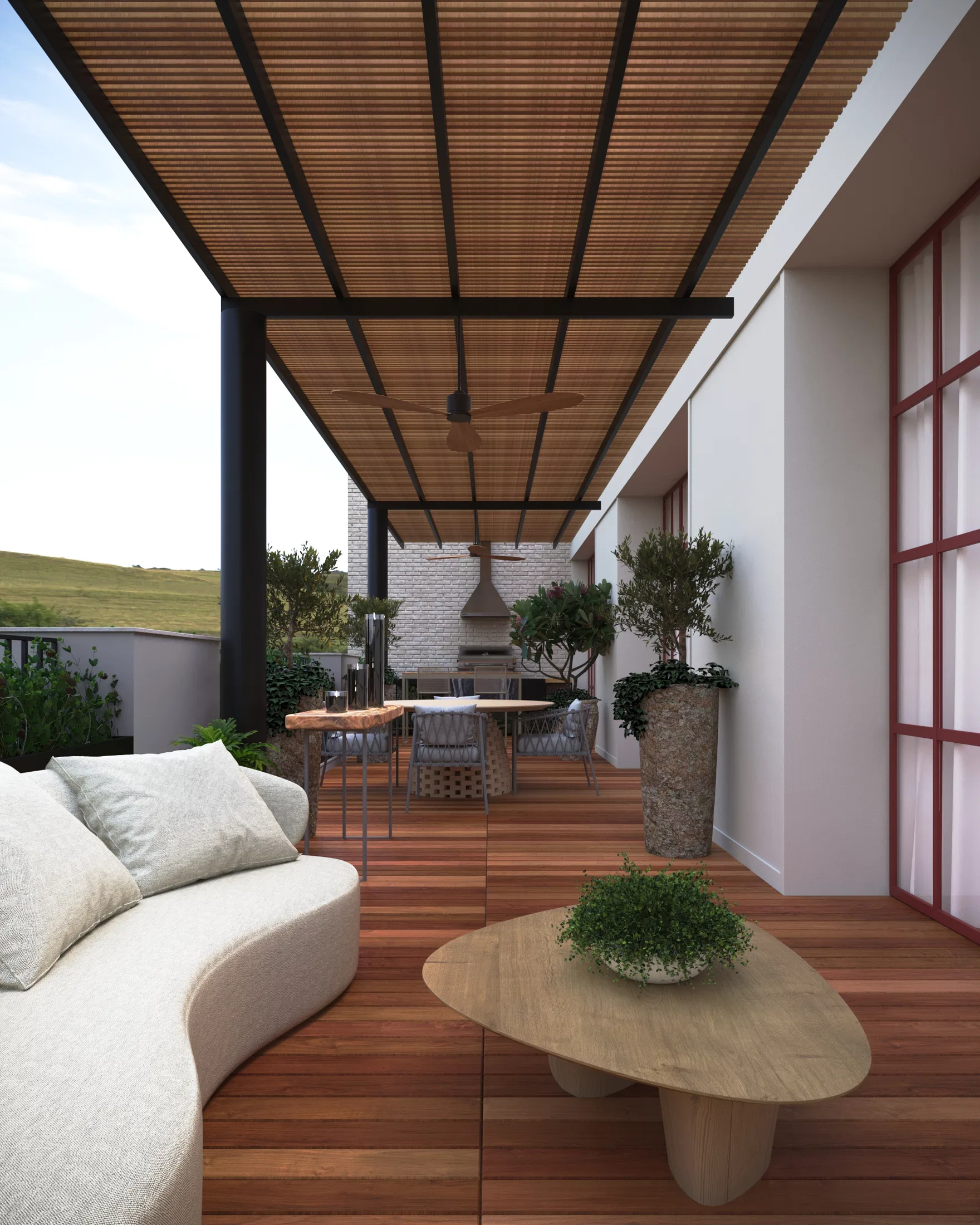 Terrace covered by a wood-slat pergola, with a curved sofa, a coffee table and a view over green open land