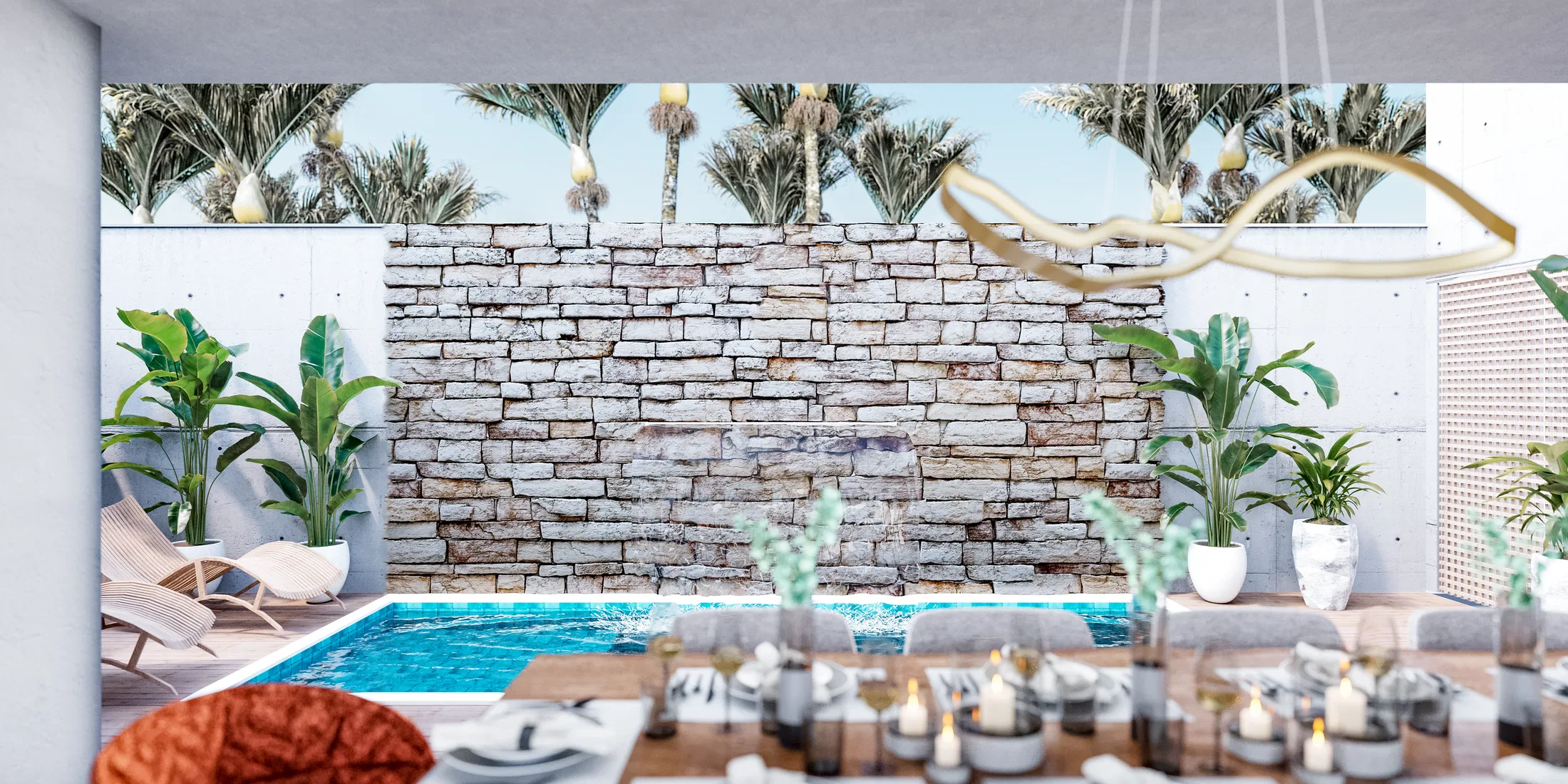 Outdoor veranda with a narrow-edge pool, an irregular stone wall behind it and a table set with candles at dusk
