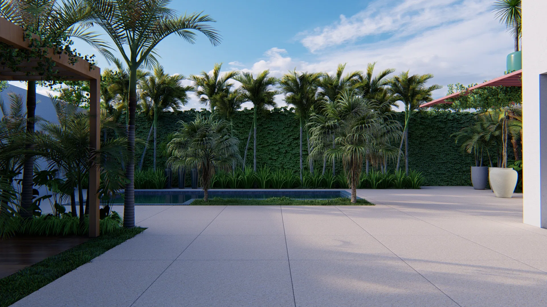 Broad backyard in pale paving, with a row of palms above a green hedge and a slim pool set behind