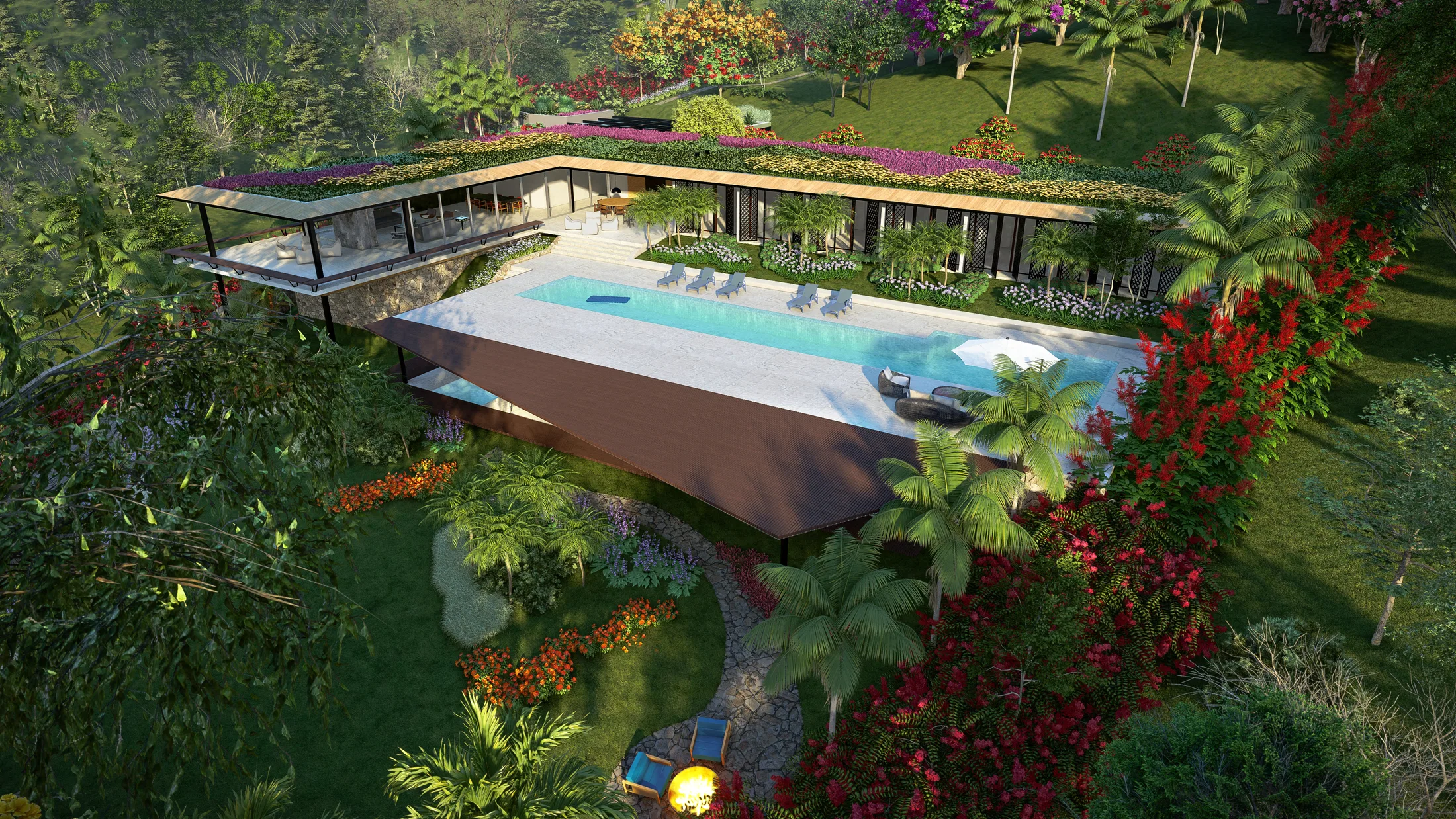 Aerial view of the infinity pool with a wood deck, the house's green roof and flowering beds surrounding it.