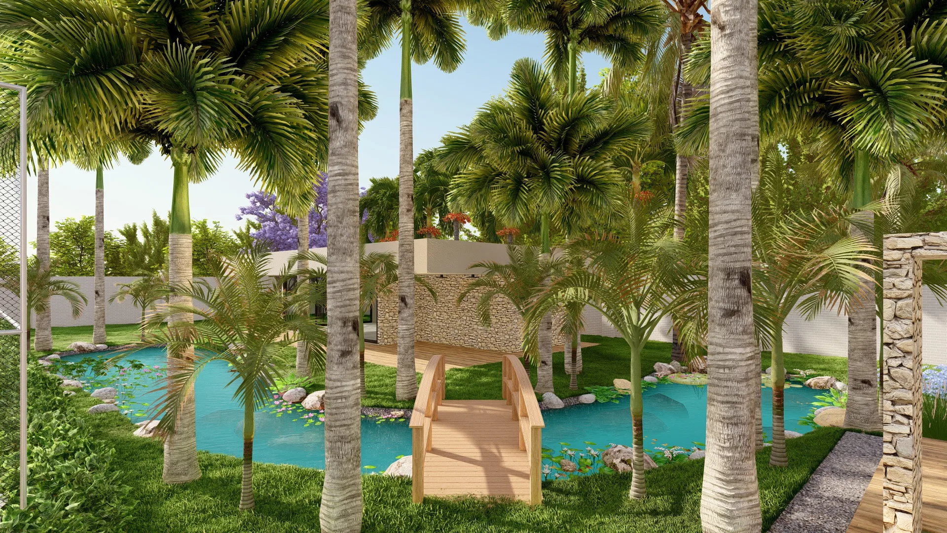 Ornamental pond among tall palms, crossed by a small arched wooden bridge, with stones at the edges and lawn all around