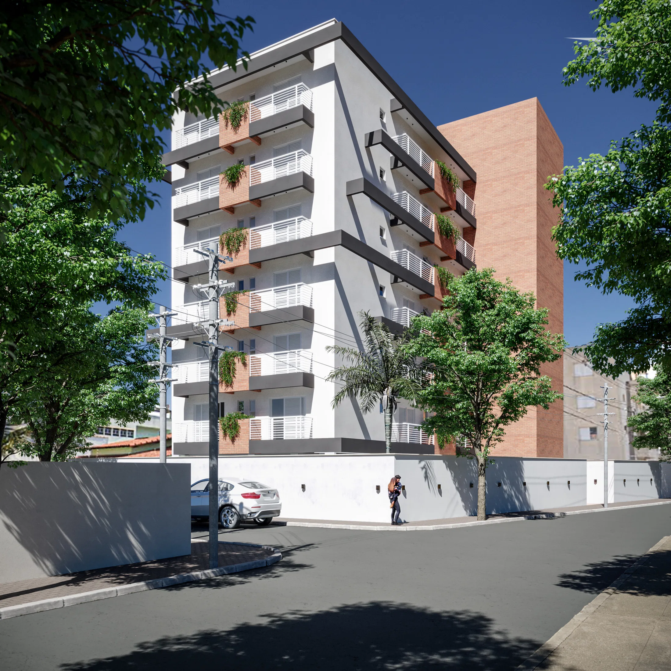 Corner view of a multi-story building with a white facade of staggered balconies and trailing greenery, a brick side volume and a white street wall