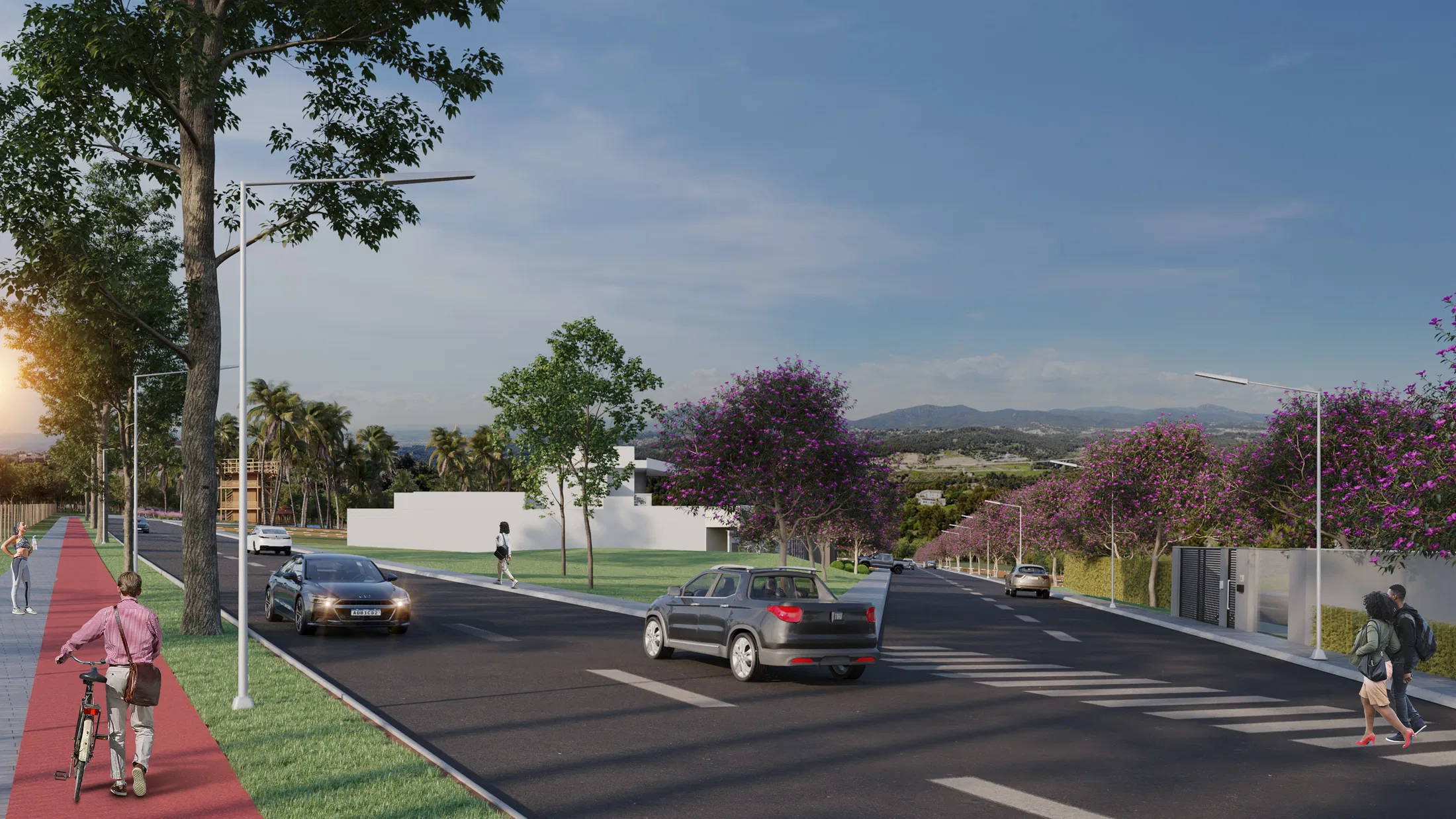 Avenue with a red cycle lane lined by purple-flowering trees, lampposts and cars, with mountains on the dusk horizon