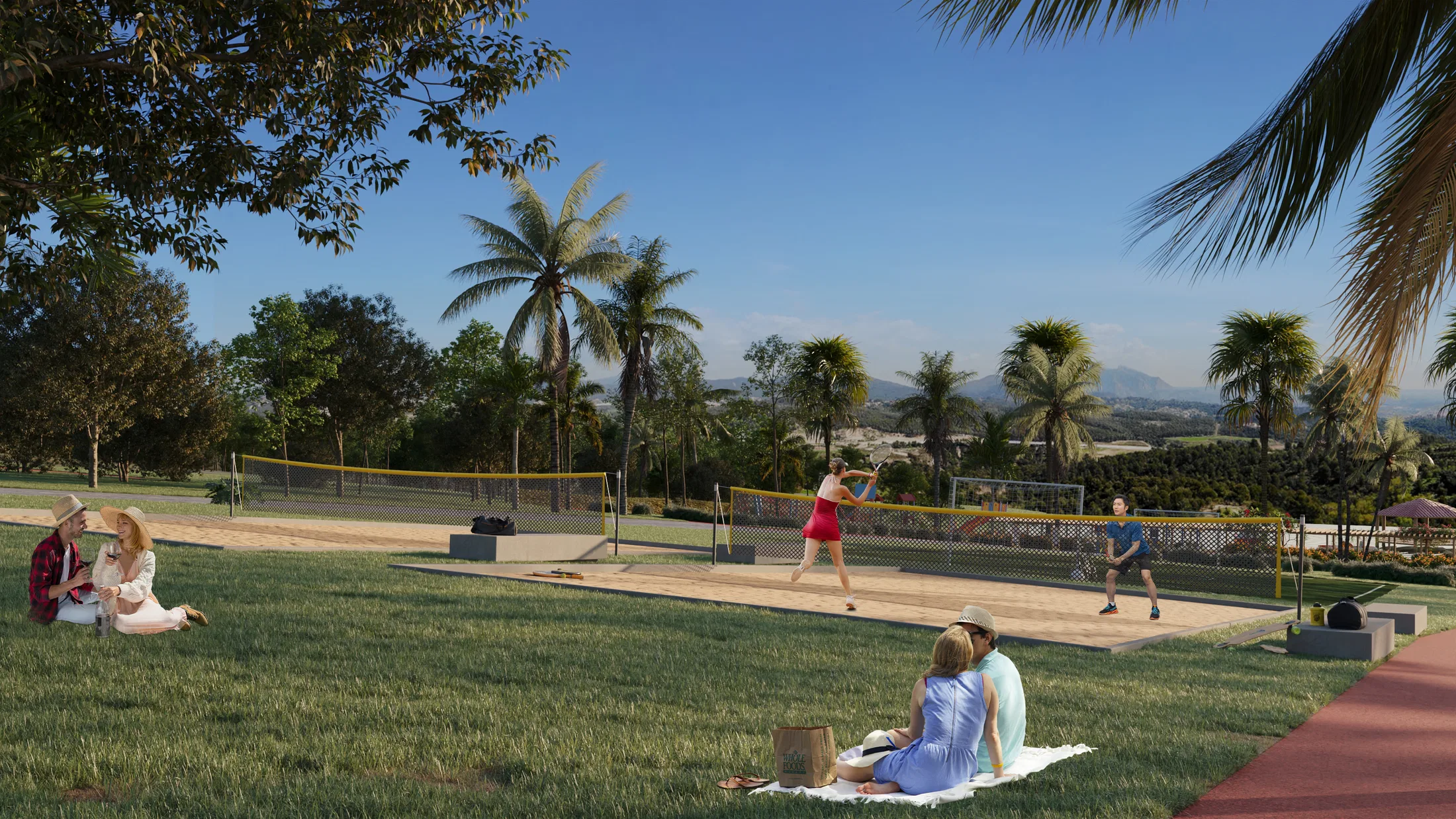 Sand court with people playing among palm trees, couples picnicking on the lawn and mountains rising in the sunny background