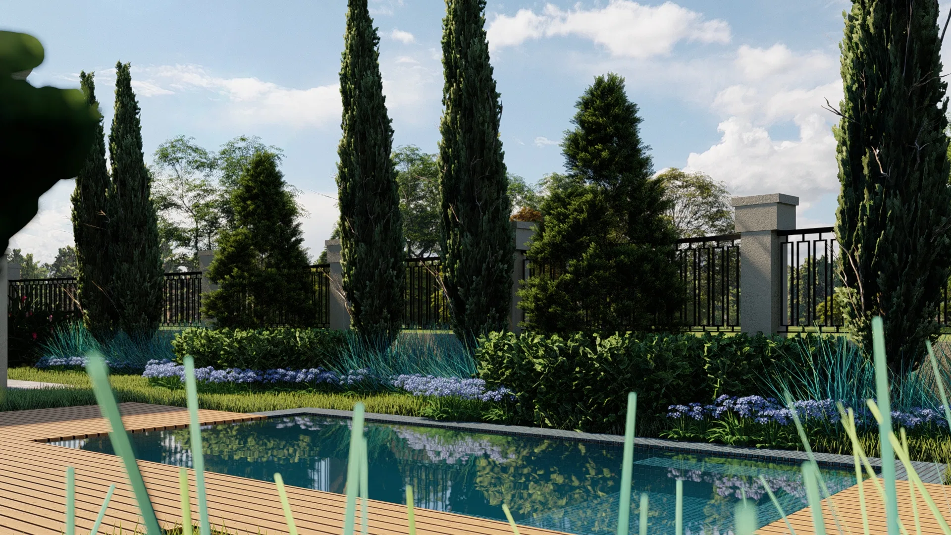 Close view of the pool, its timber deck mirroring the cypresses, a dark metal railing on masonry piers and borders of blue agapanthus.