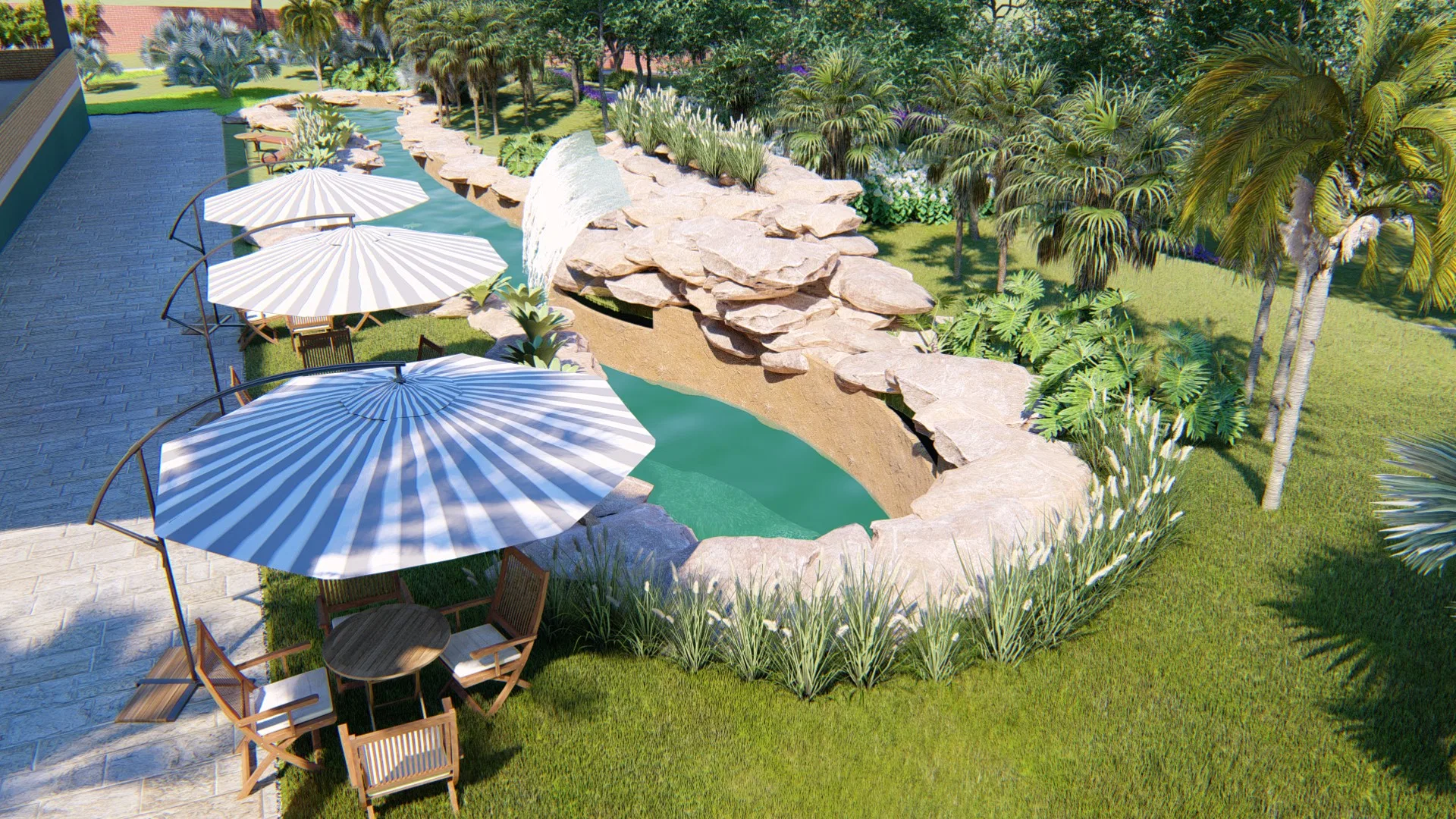 Aerial view of the rock-edged pool with a waterfall, blue-and-white striped parasols over timber loungers and a tropical garden around
