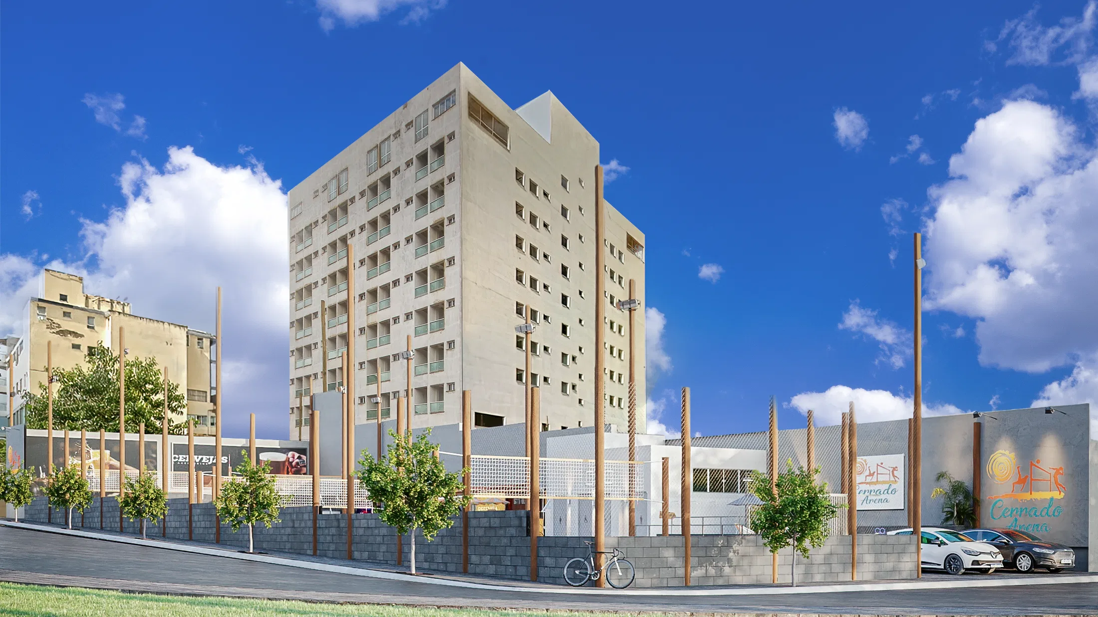 Street view of the complex, with a block wall and vertical wooden posts, trees, a bicycle and parked cars before a residential tower