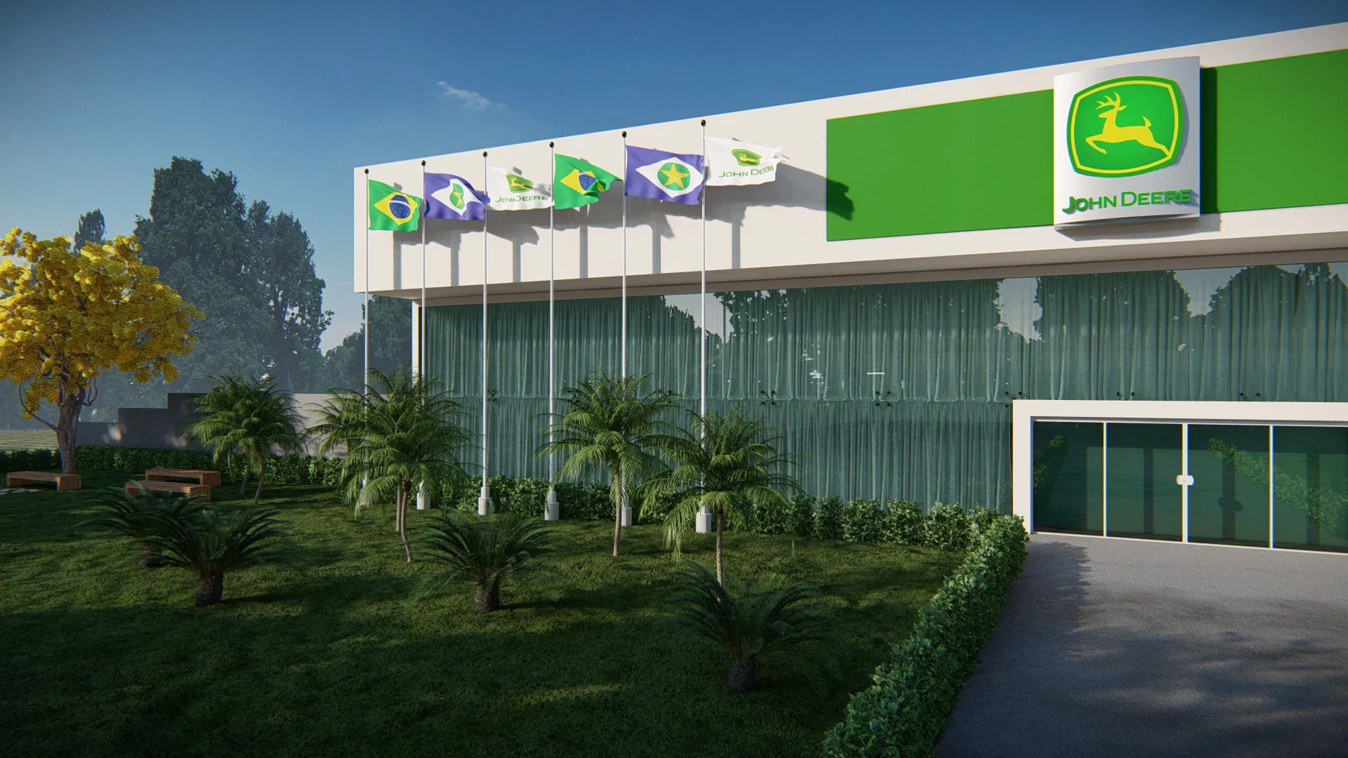 Glazed dealership facade with a green fascia, a row of flags, young palm trees and a yellow-flowering tree on the lawn