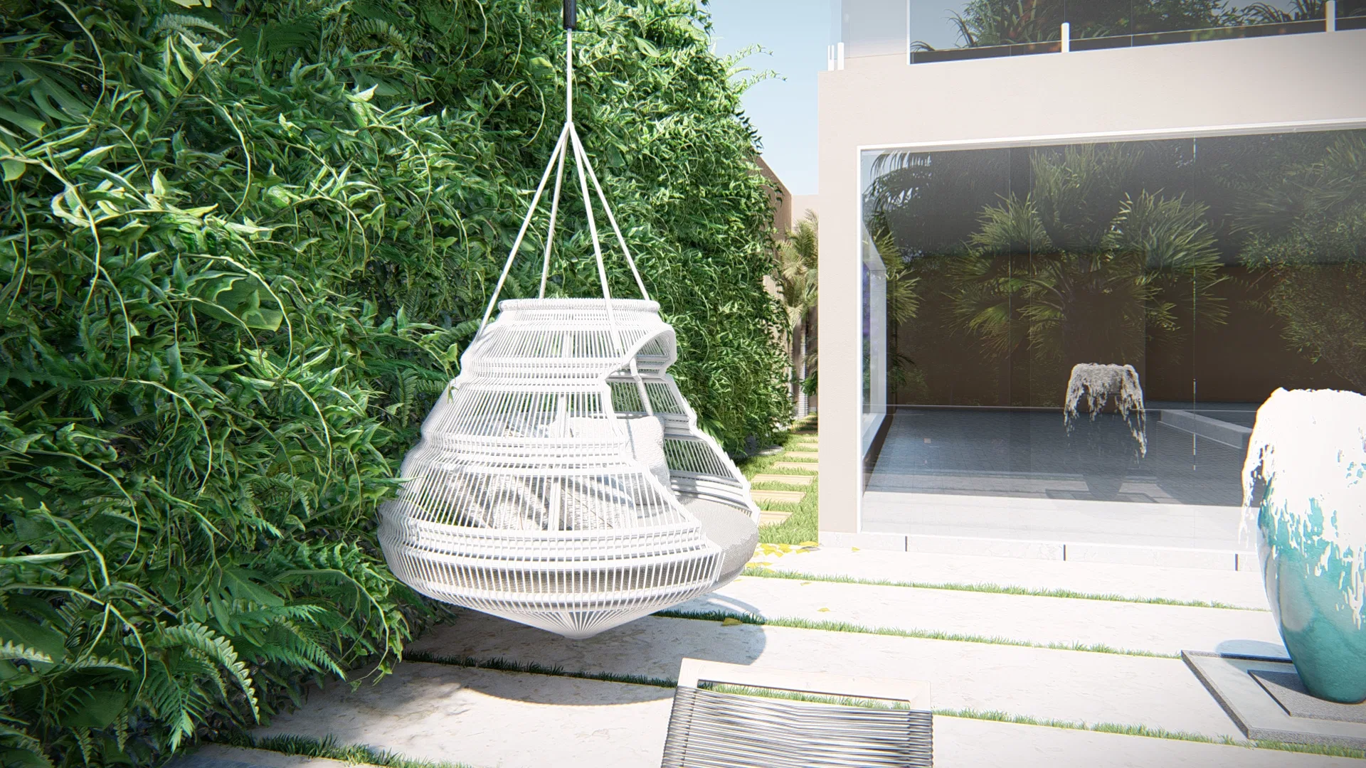 White woven hanging nest chair suspended before a lush vertical hedge, beside a mirrored glass wall and grass-jointed stone paving