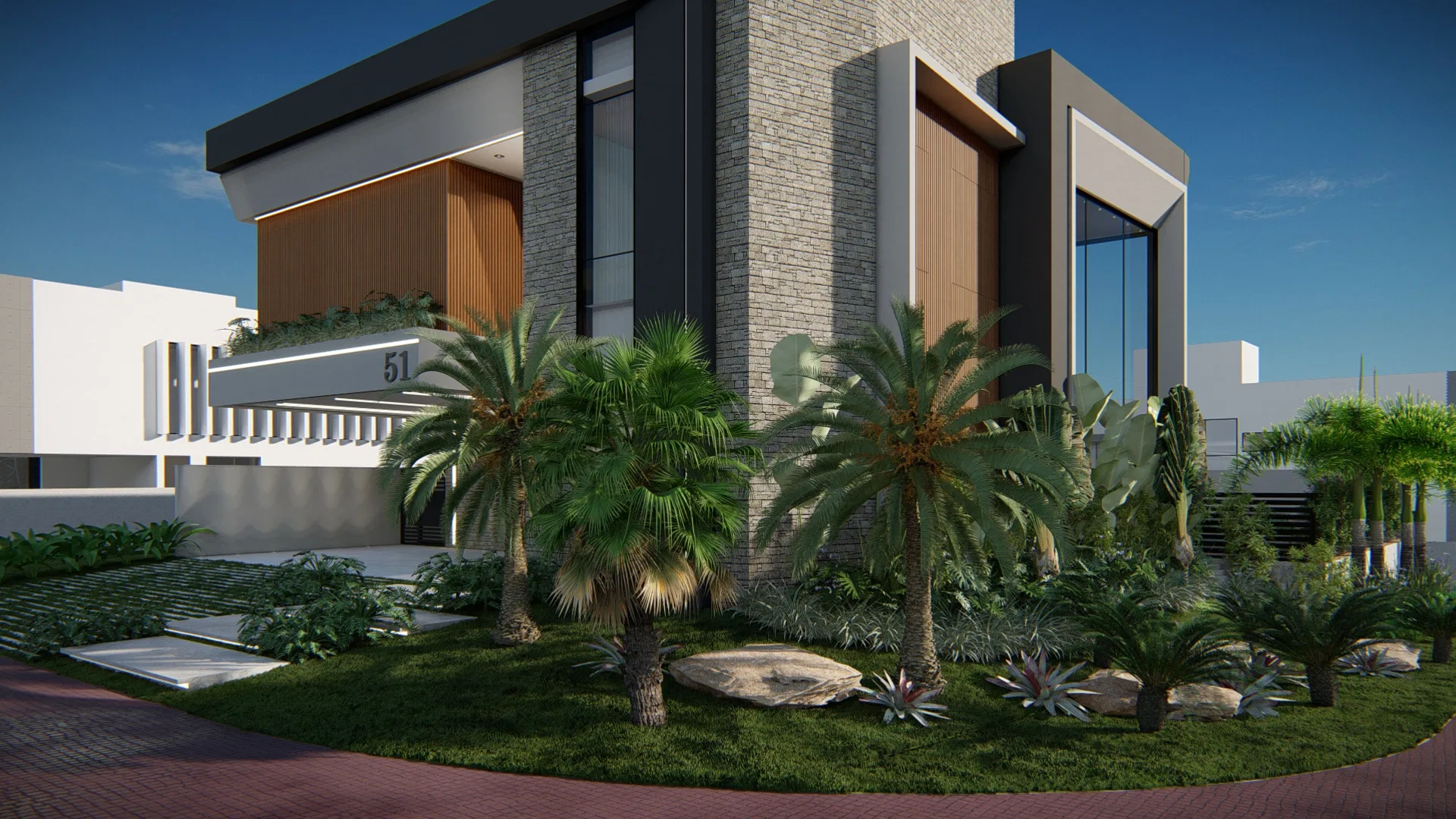 Angled view of the facade with a dense tropical garden — palms, cycads, bromeliads and boulders on the lawn before the stone-clad volume.