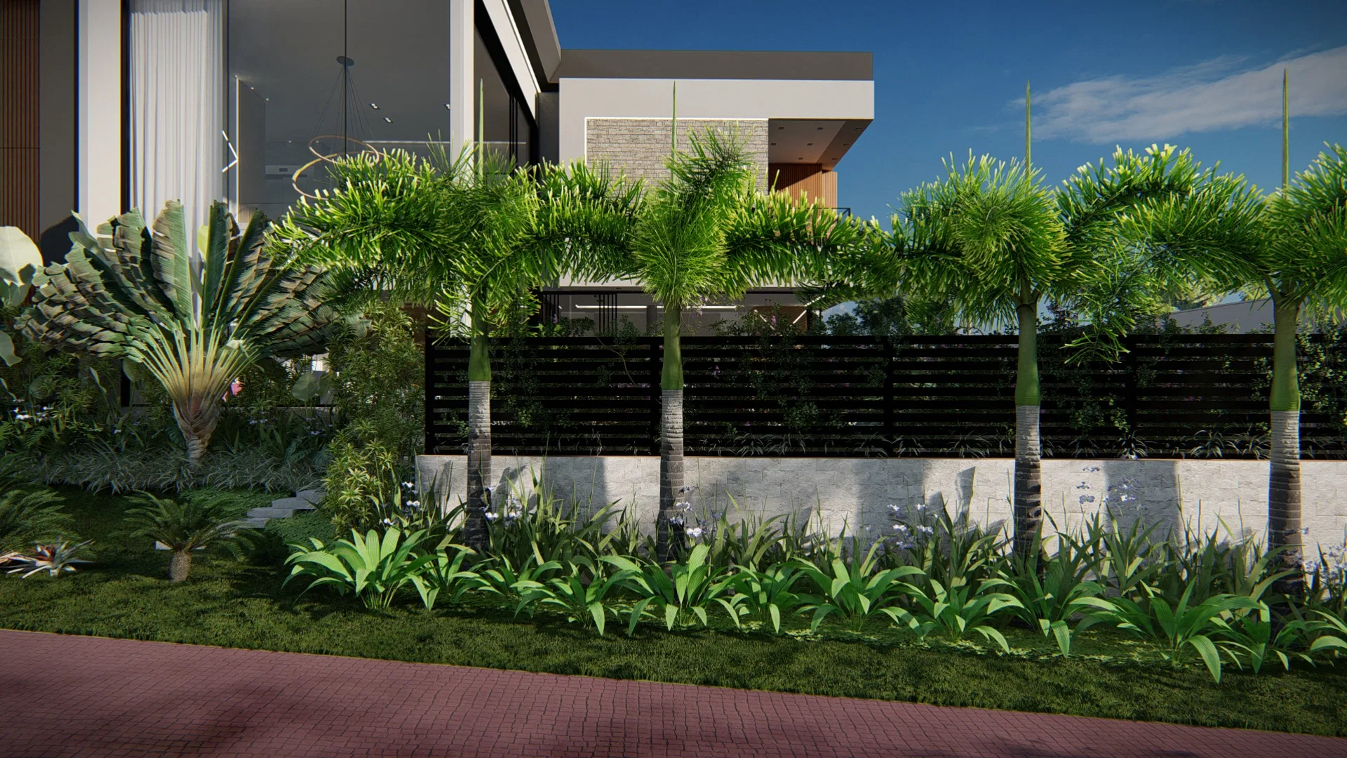 Row of palms along a dark-slat fence above a stone wall, with a bed of strap-leaved plants and a brick-paved driveway in the foreground.