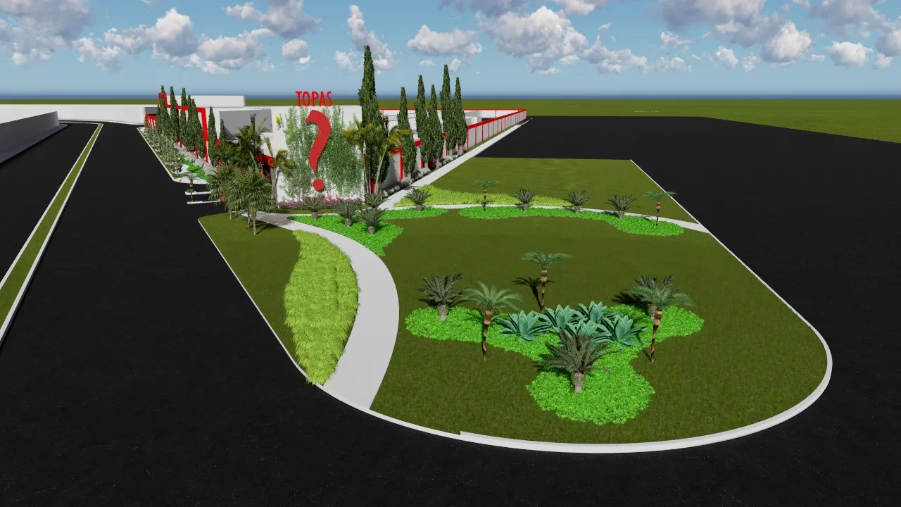 Wide view of the commercial lot, a grassy island with palms and agaves between the paved street and the red facade beyond.