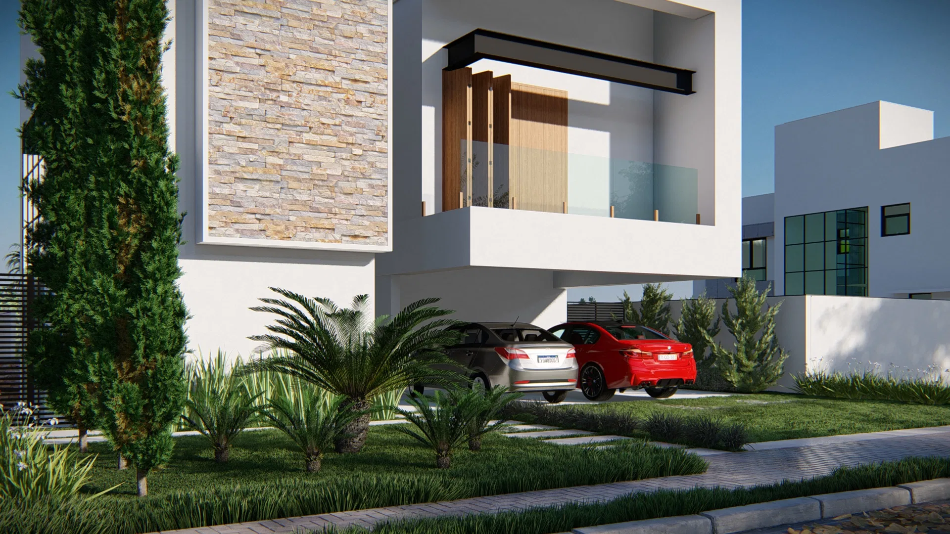 Angled view of the facade, with the stone panel, a cycad palm and planted beds before the two-car garage