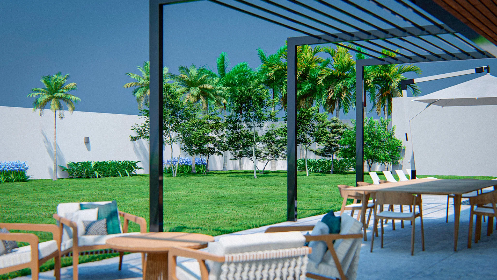 Terrace shaded by a metal pergola with a dining table, woven armchairs and a parasol, opening onto a lawn with palms and agapanthus