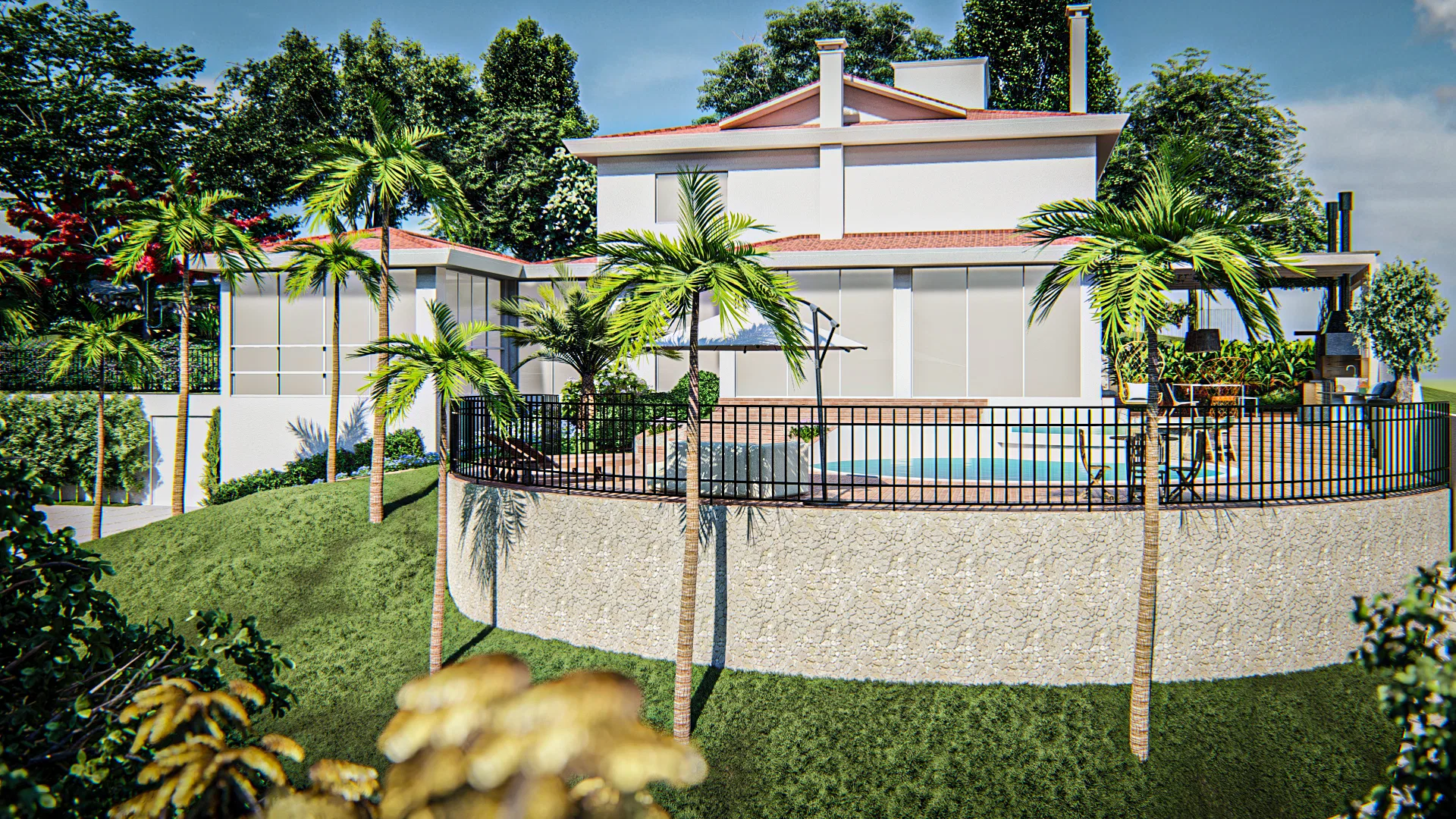 Rear of the house with a curved pool on a stone-clad terrace, ringed by palms and railing above the sloping lawn.