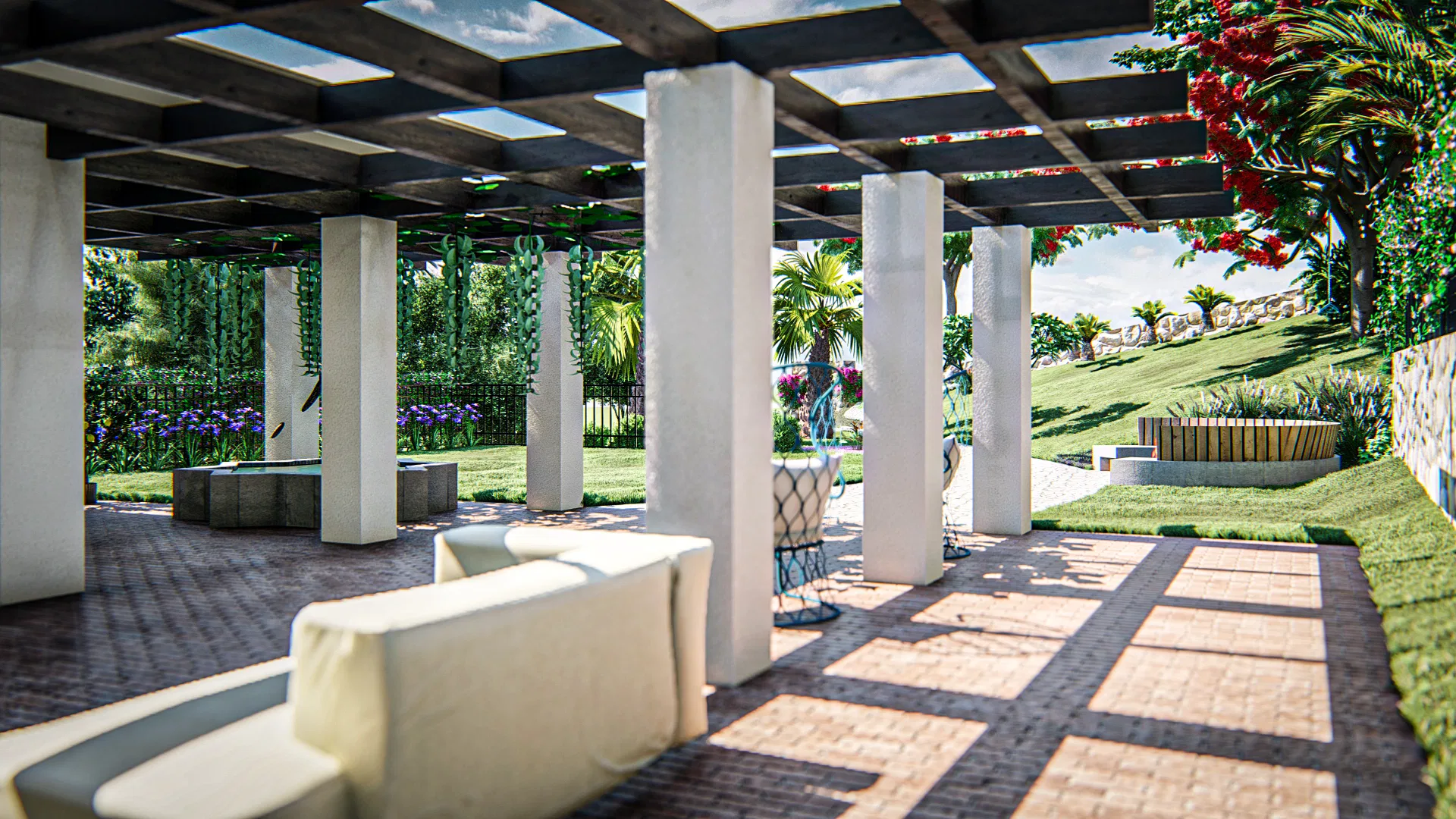 Pergola-covered lounge with white columns, an upholstered sofa and brick paving, opening to a garden of agapanthus and climbers.