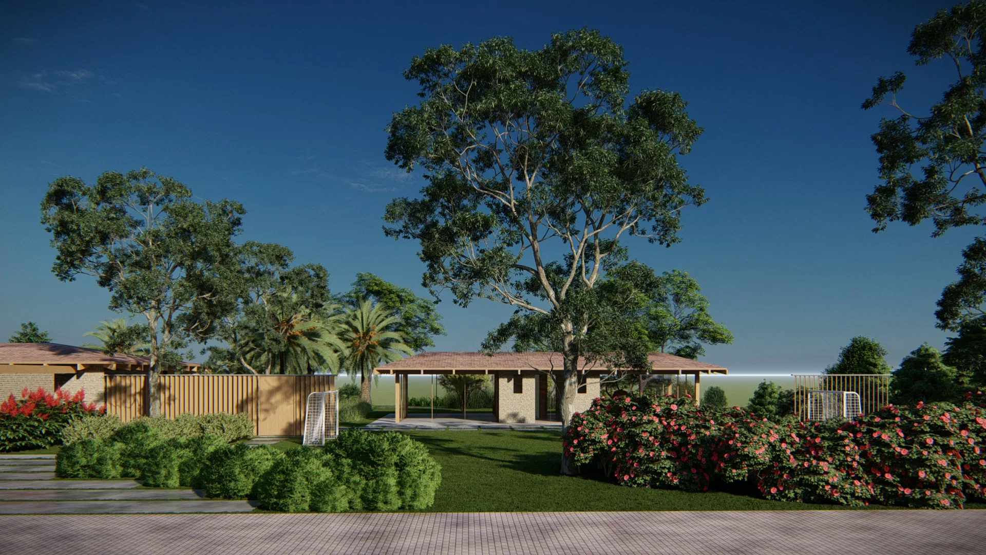 Dusk view of the property, with screened pavilions and pitched roofs among tall eucalyptus and pink-flowering shrubs.