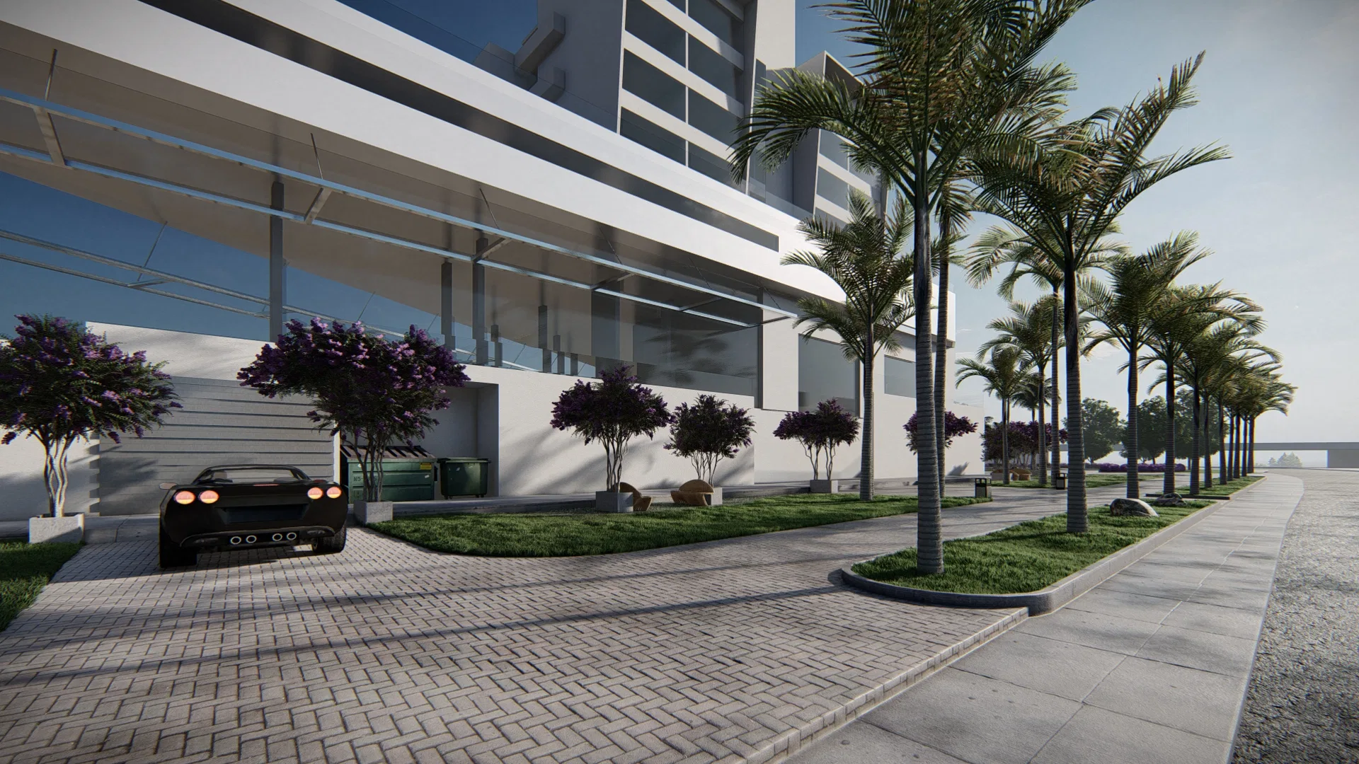 Paved driveway to the development, lined with palms, purple-flowering trees and a dark sports car beside the glass façade.