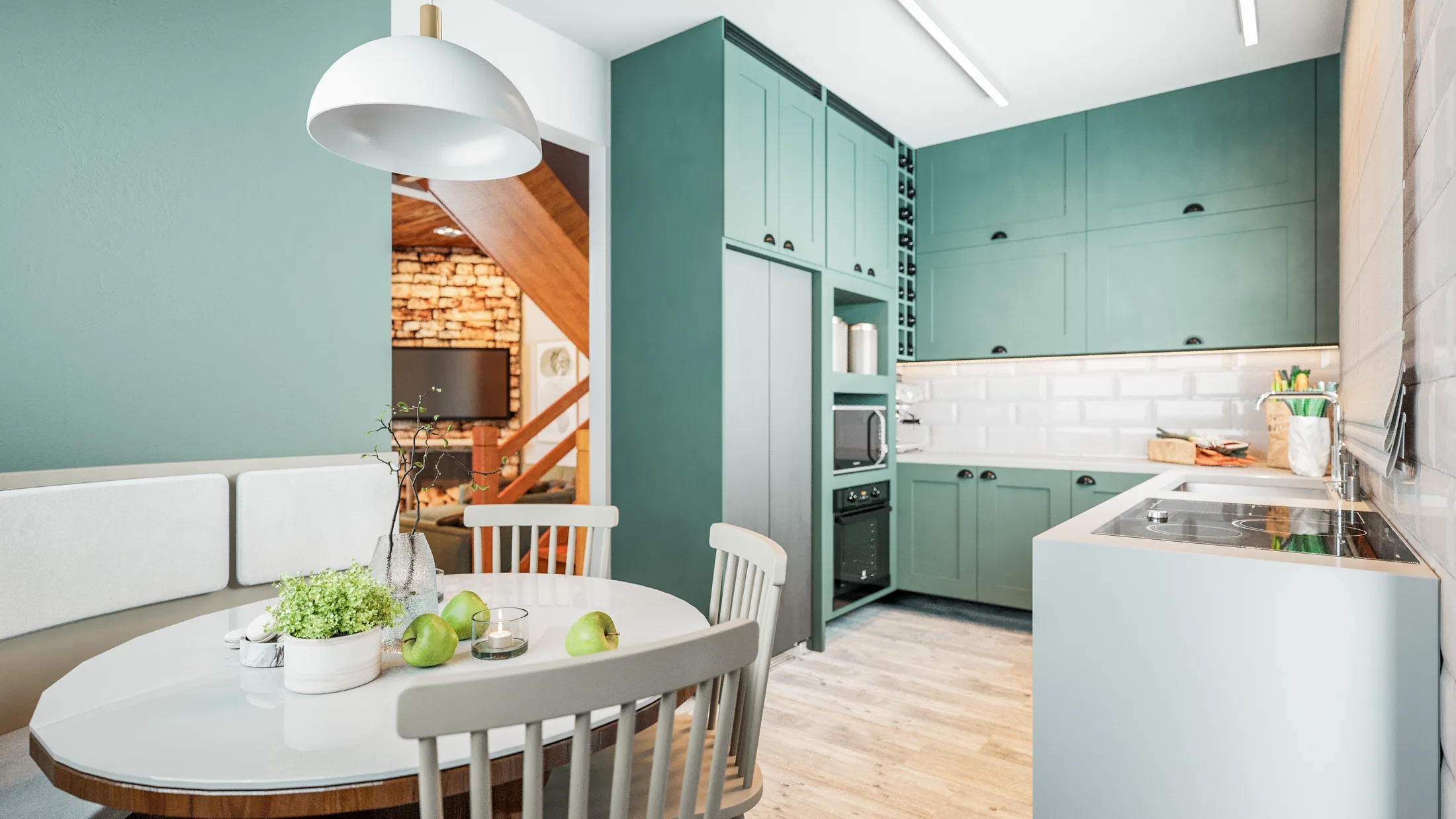 Open kitchen with sage-green cabinetry, a round dining table and a view toward the living room fireplace beyond