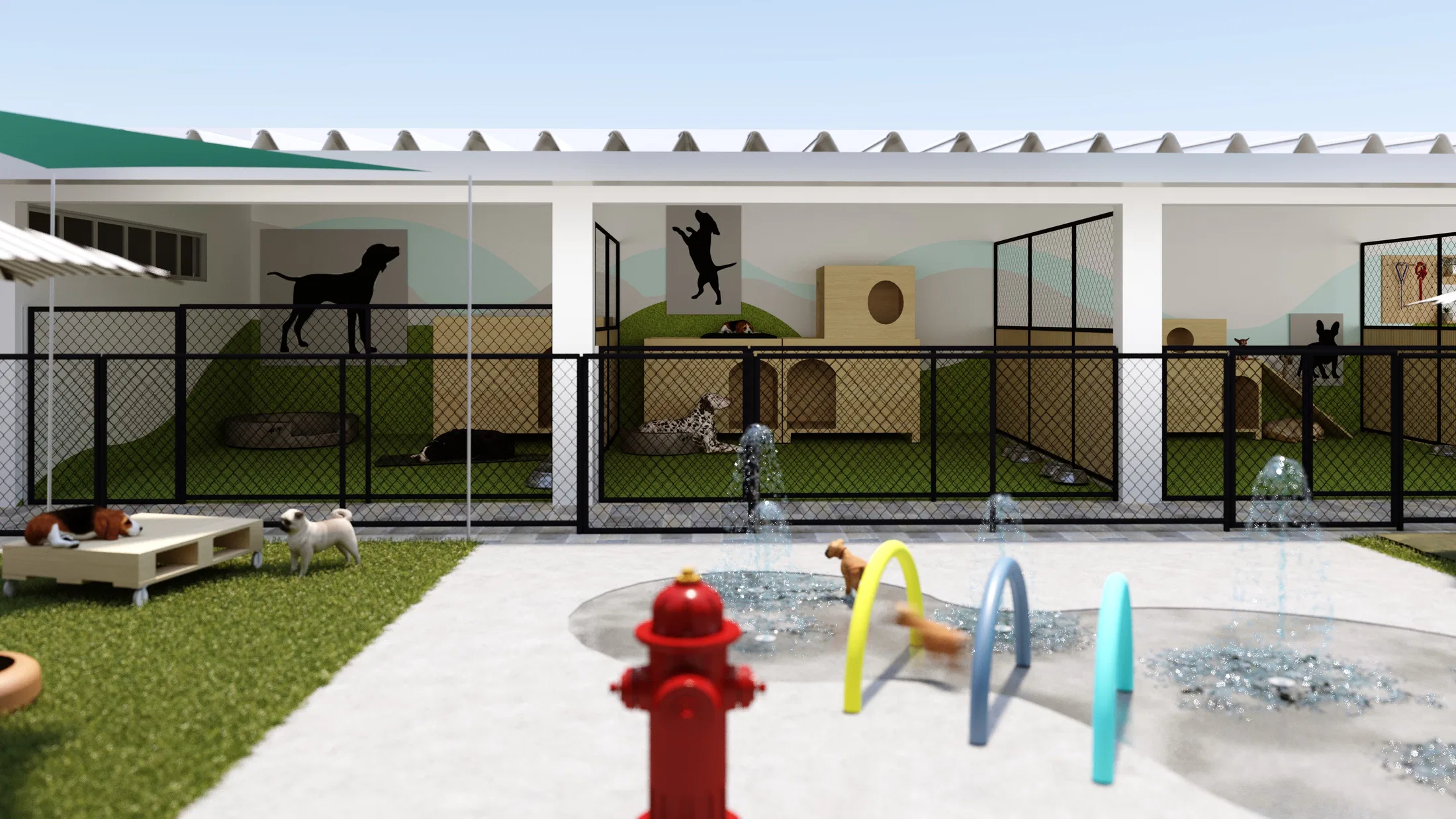 Covered kennels under corrugated roofing with mesh fencing, wooden dog houses and dog silhouettes on the walls, facing the water playground.