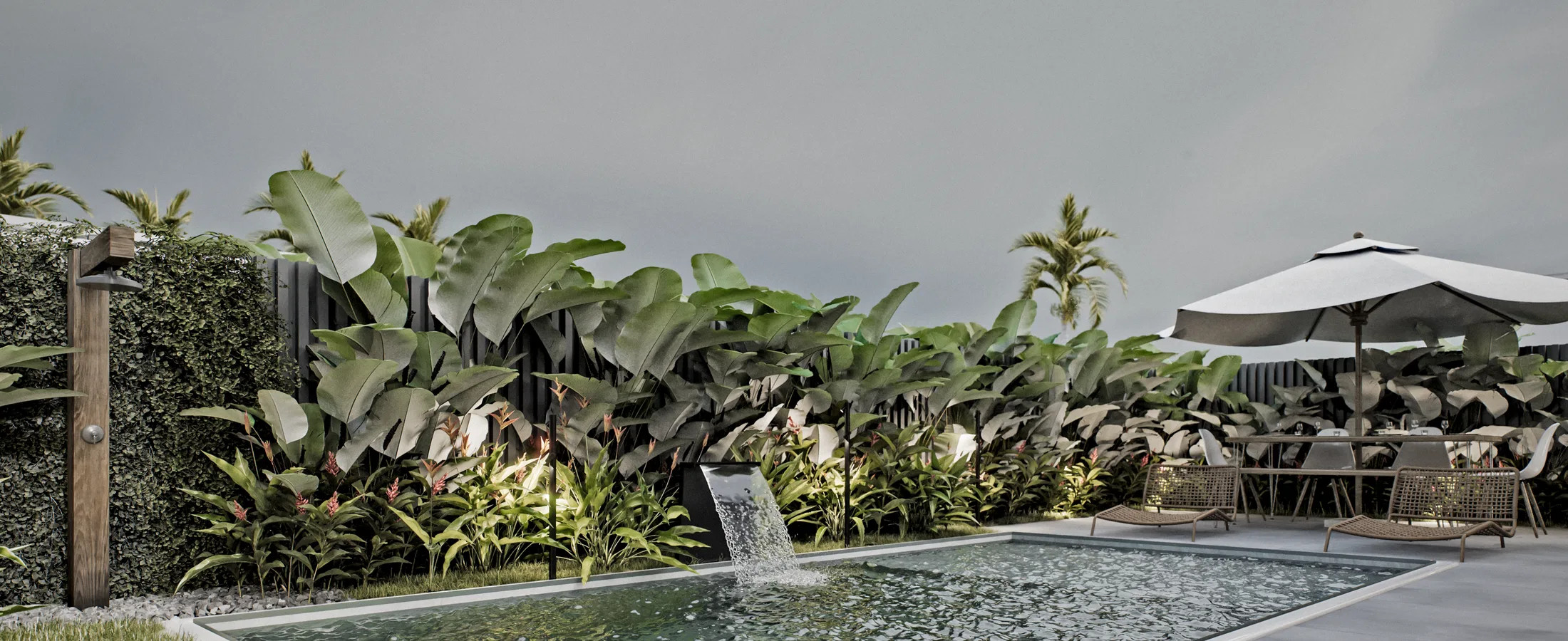 Pool with a cascading water blade over a green wall and a lit tropical bed, a wooden outdoor shower on the left and a dining set on the right.