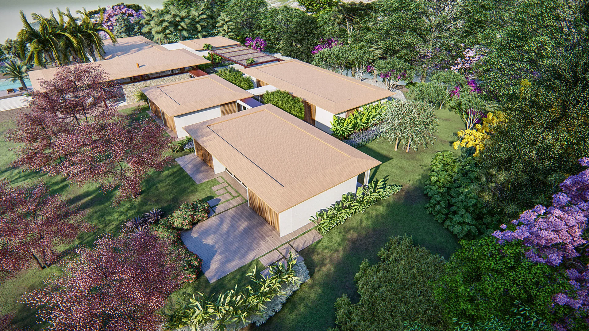 Aerial view of the residential complex with connected rooftops, pink-flowering trees and garden surrounding the buildings.