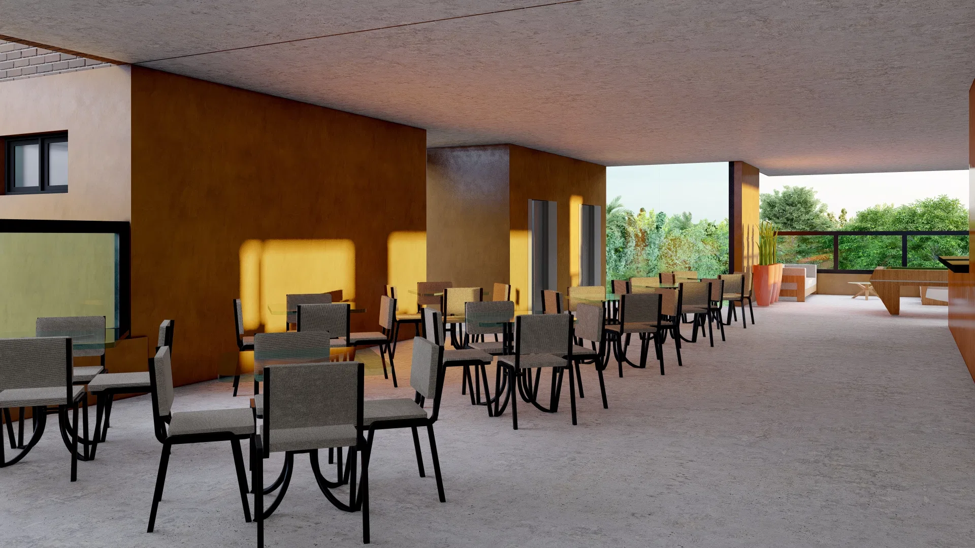 Covered gourmet terrace with rows of tables and chairs, ochre-toned walls and warm evening light from the open side