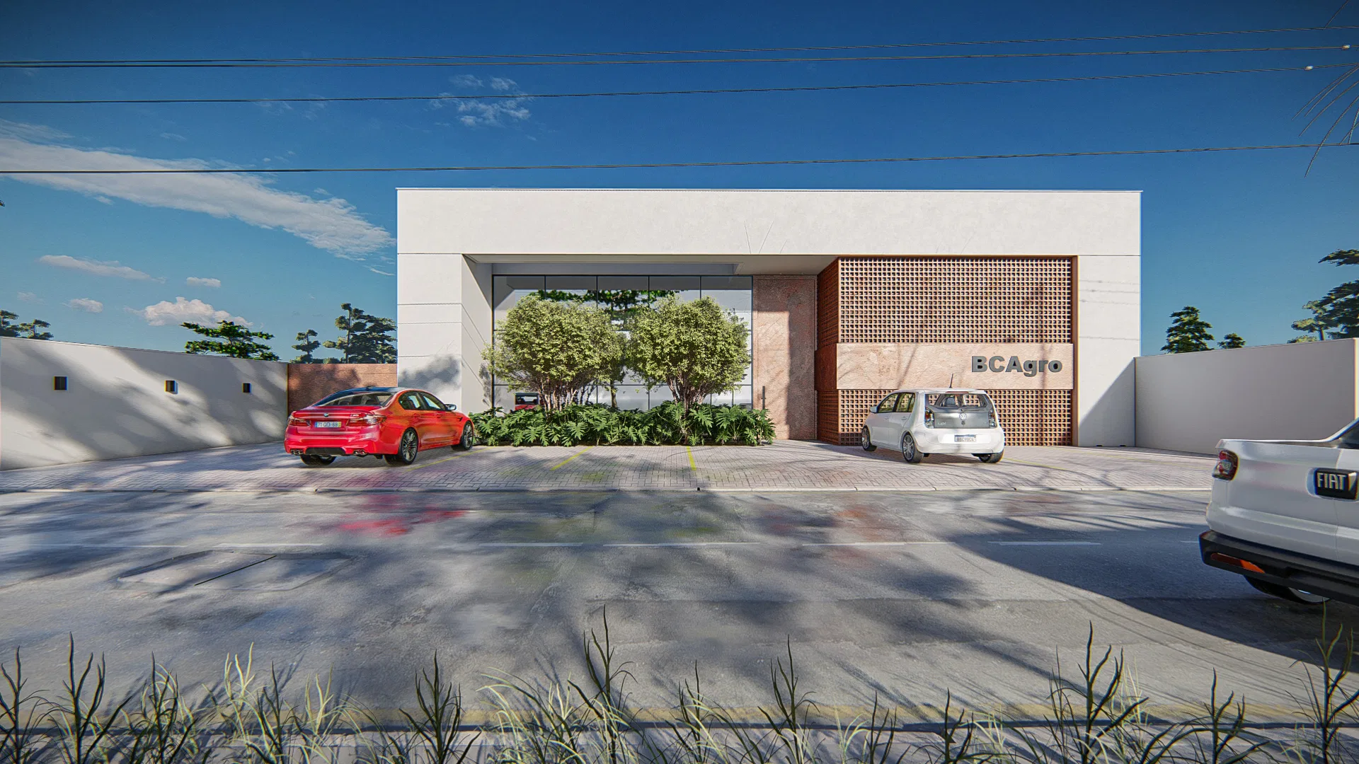 White commercial headquarters facade with a BCAgro sign, perforated wood screen and a planted island of rounded shrubs, cars parked in front