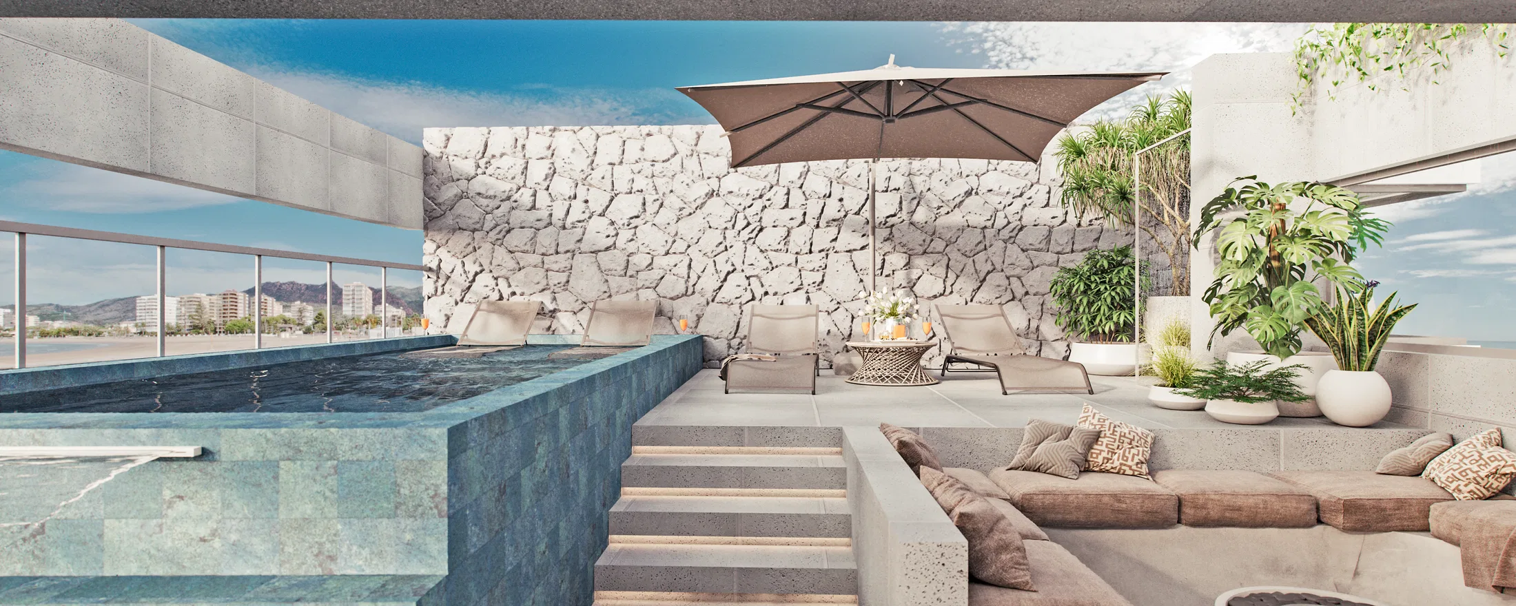 Sun loungers under a large parasol against a rough stone wall, a modular sofa in the foreground and a glass rail above the city.