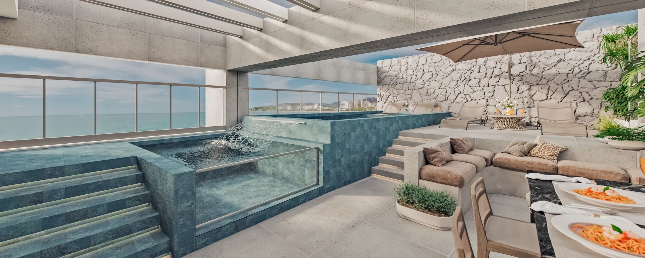 Rooftop terrace with a glass-edged green-tiled pool, a lounge under a parasol, a pale stone wall and a view over the coastline.
