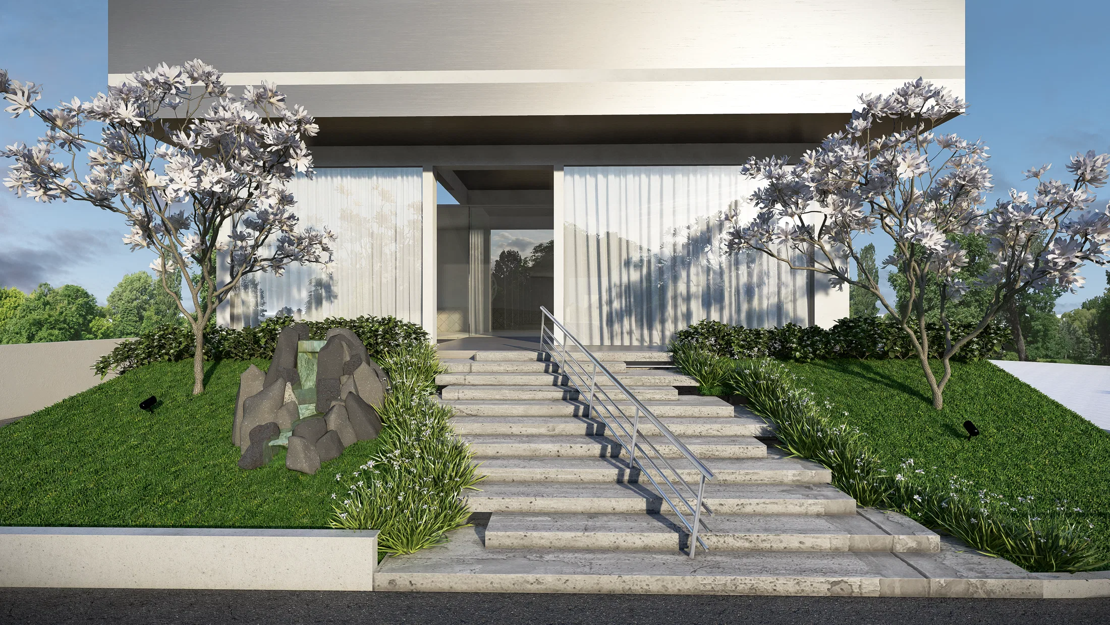 The same access in daylight, with wide steps, a rock-and-water garden on the left and flowering groundcover framing the stairs