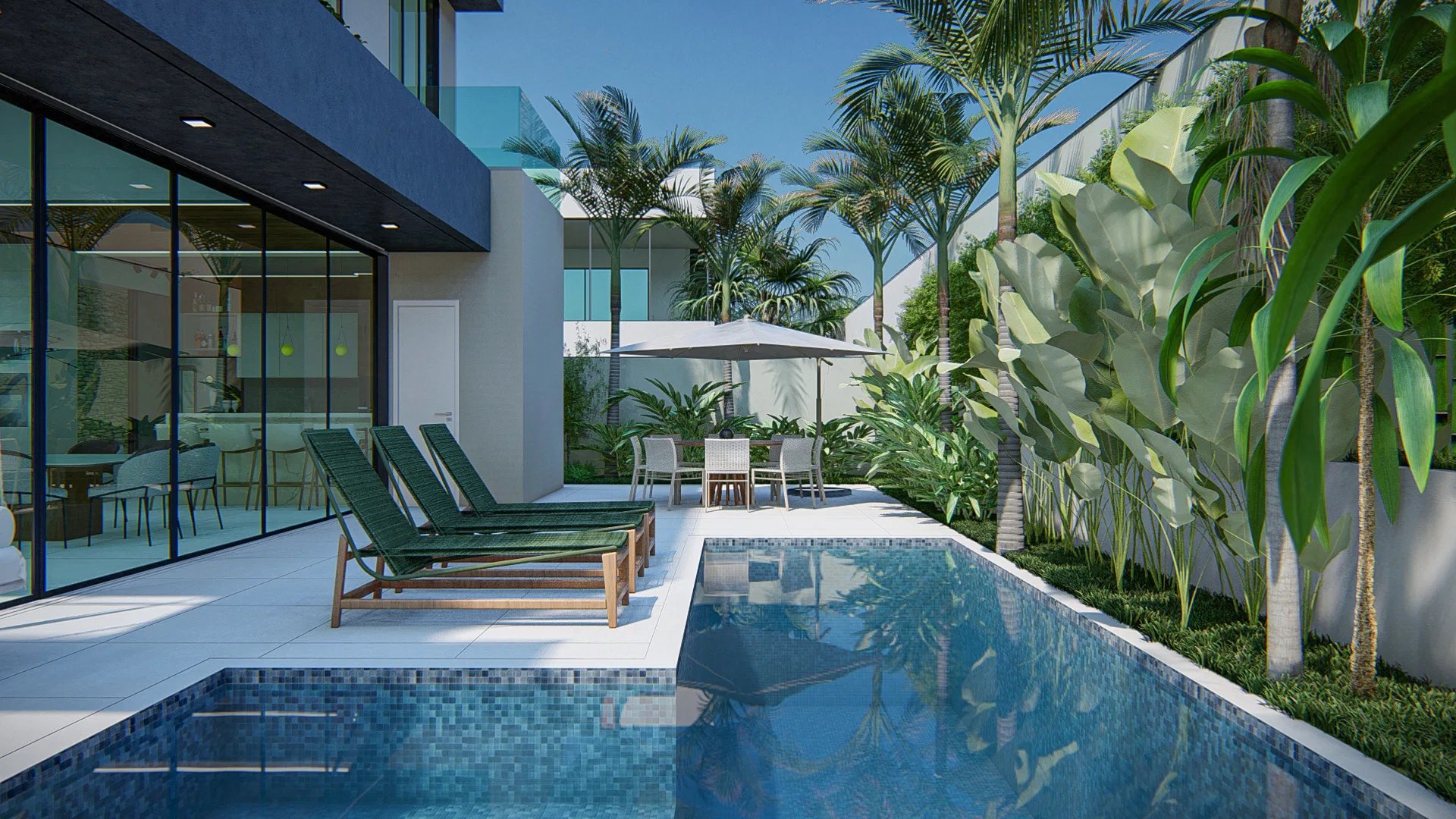 Pool area with blue tiling, wooden loungers with green cushions and a dining set under a parasol beside the glass-walled house
