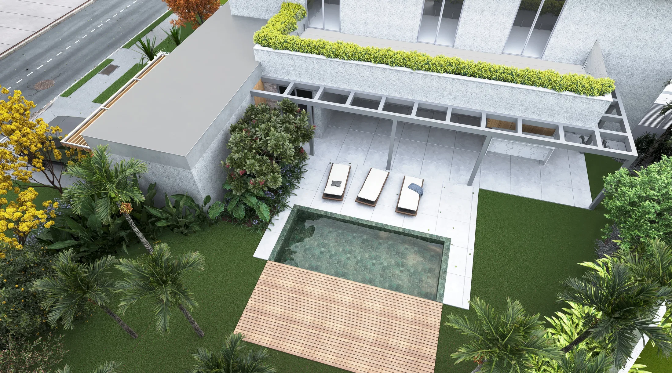 Aerial angle of the rectangular pool area with a timber deck, three loungers and a green raised planter running along the façade.