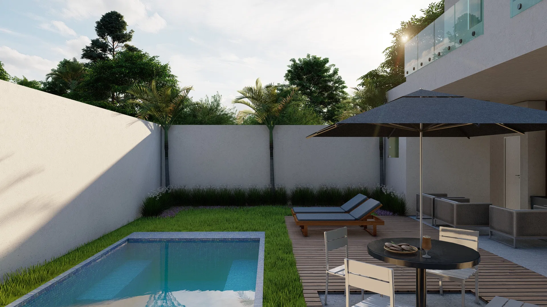 Backyard with a rectangular pool, wood deck, sun loungers, a table with a parasol and armchairs, enclosed by white walls and palms