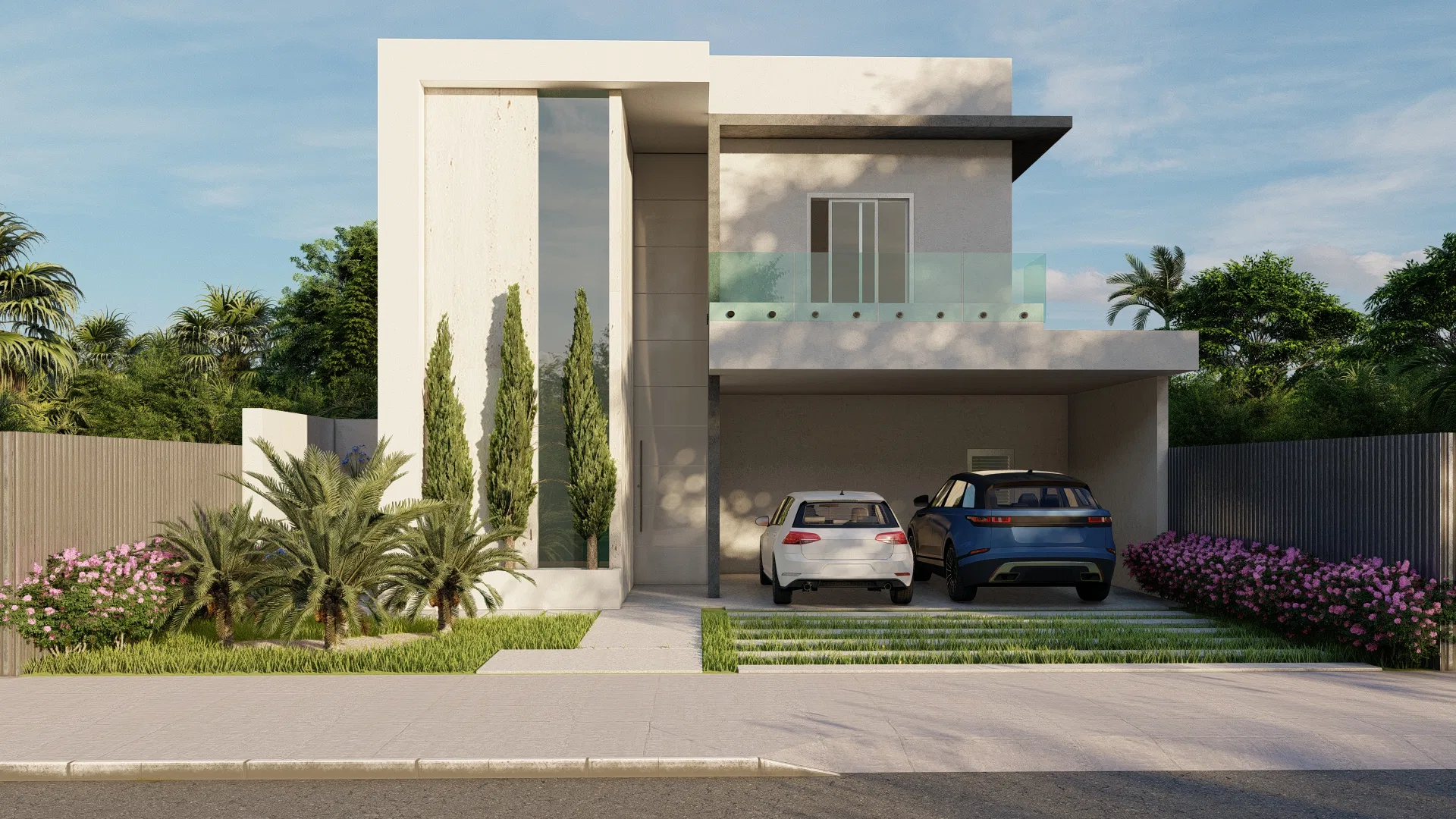 Two-story facade with a glass-railed balcony and a covered garage sheltering two cars, flanked by cypresses, palms and flowering beds