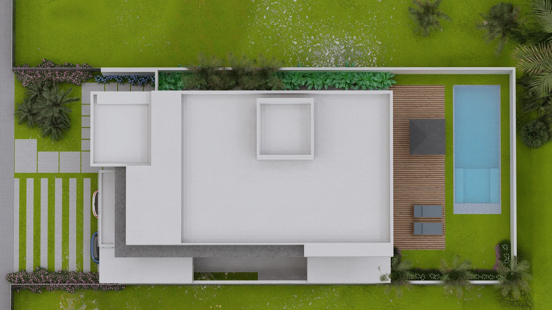 Aerial top-down view of the lot with the home's white roof, deck and pool at right, planting beds, lawn and a striped driveway at left