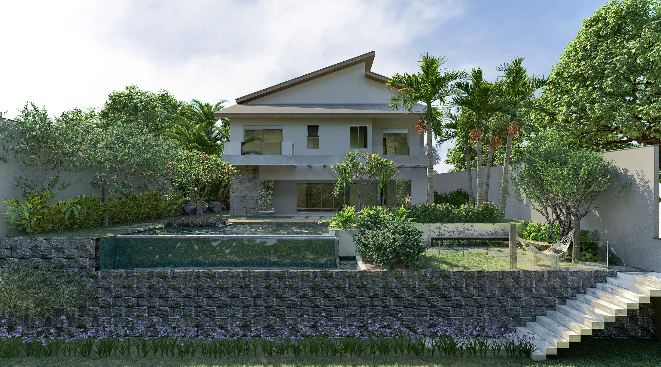Rear of the two-story house seen from the terraced garden, with a gabion wall, a green-tiled pool, palms and a hammock