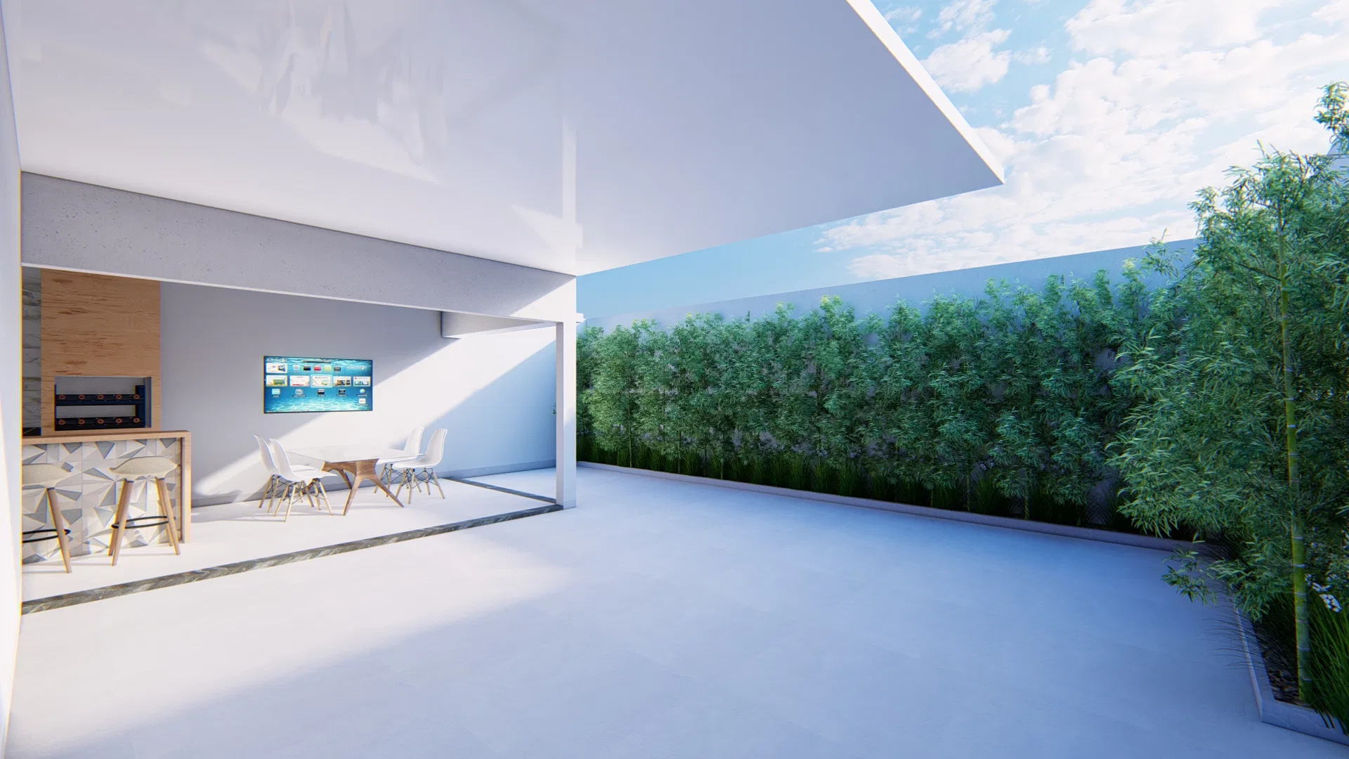 Gourmet area under a perforated canopy with a kitchen island, wall-mounted TV, dining table and chairs, with a hedge in the background