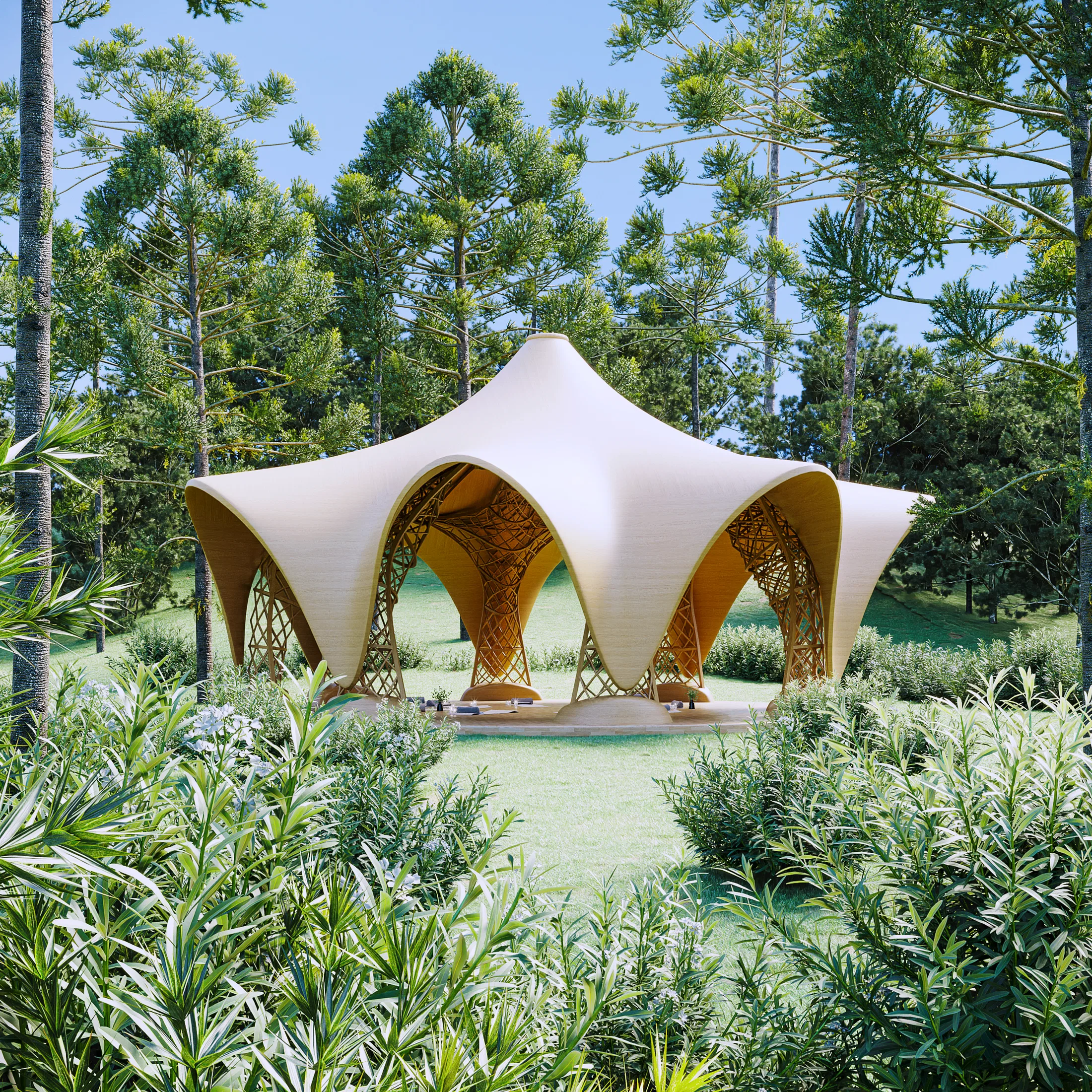 Star-shaped pavilion with a curved pale-timber canopy, seen through flowering shrubs in a grassy clearing ringed by pines.
