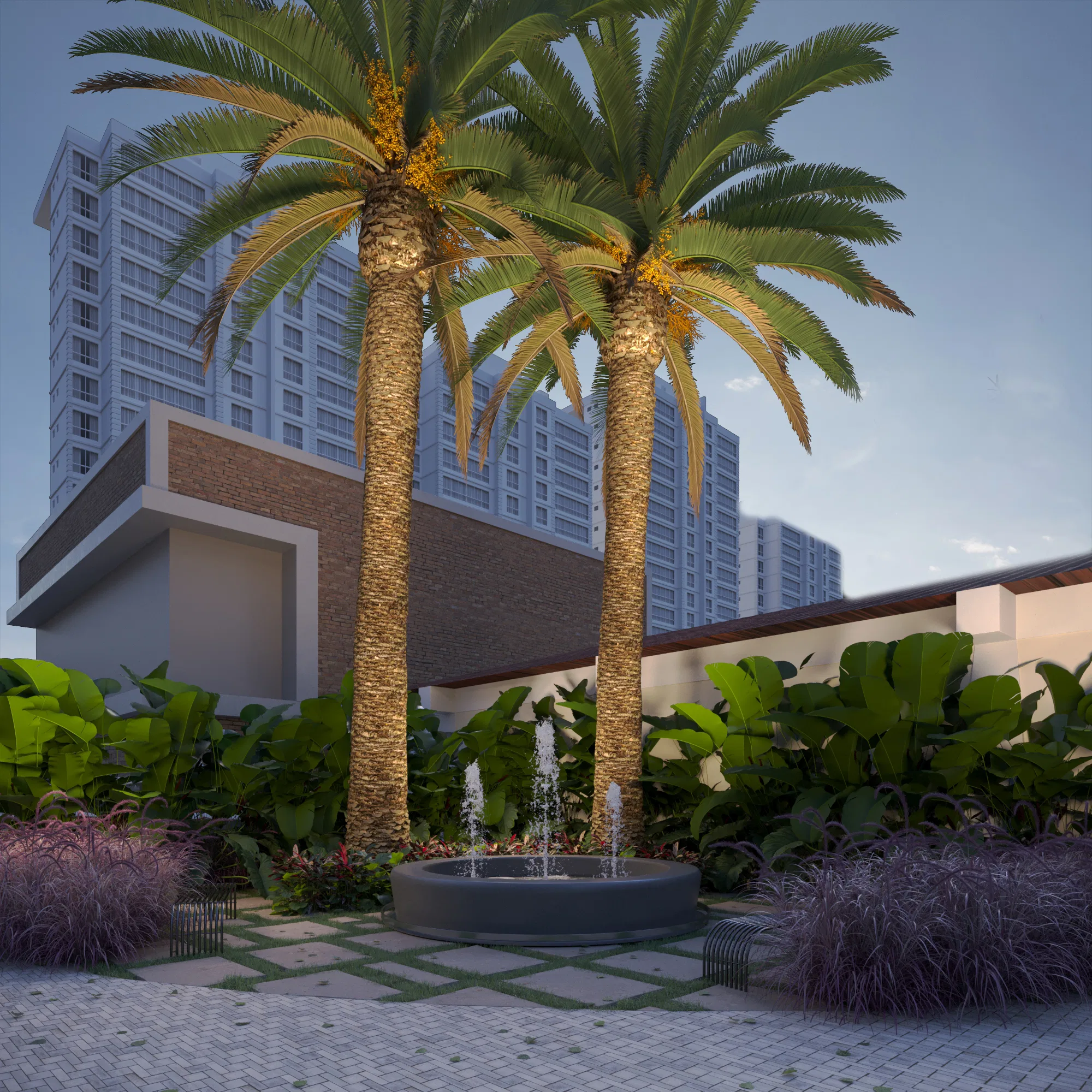 Two uplit palm trees frame a round fountain, with a residential tower rising behind and beds of foliage and purple grass