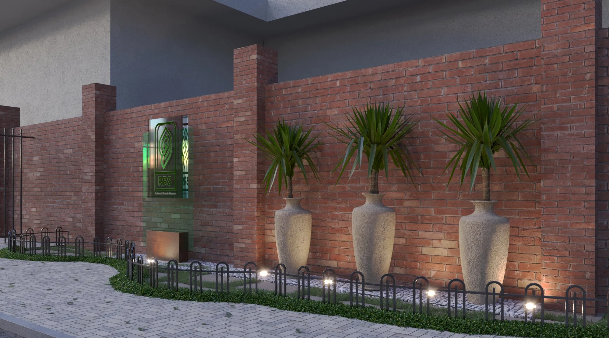 Nighttime entrance composition, with three dracaena urns aligned along a brick wall and an illuminated plaque beside the low railing